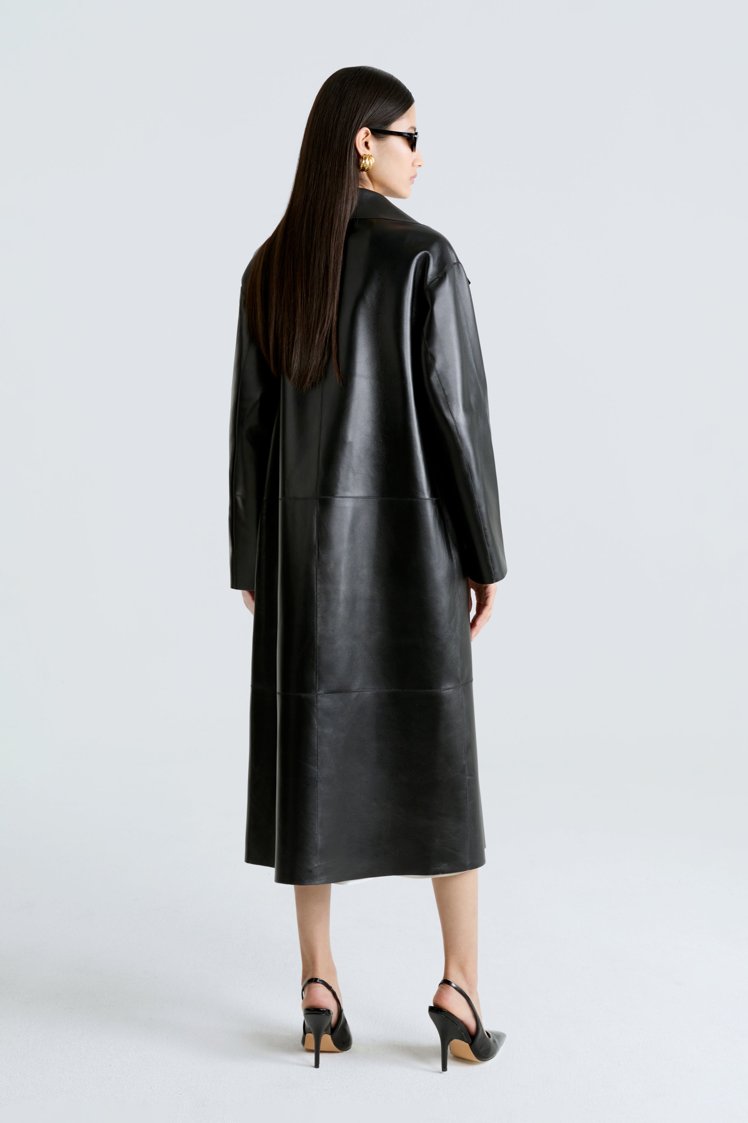 Model is wearing the Nour Hammour Birthday Coat Leather Black Draped Leather Coat Back
