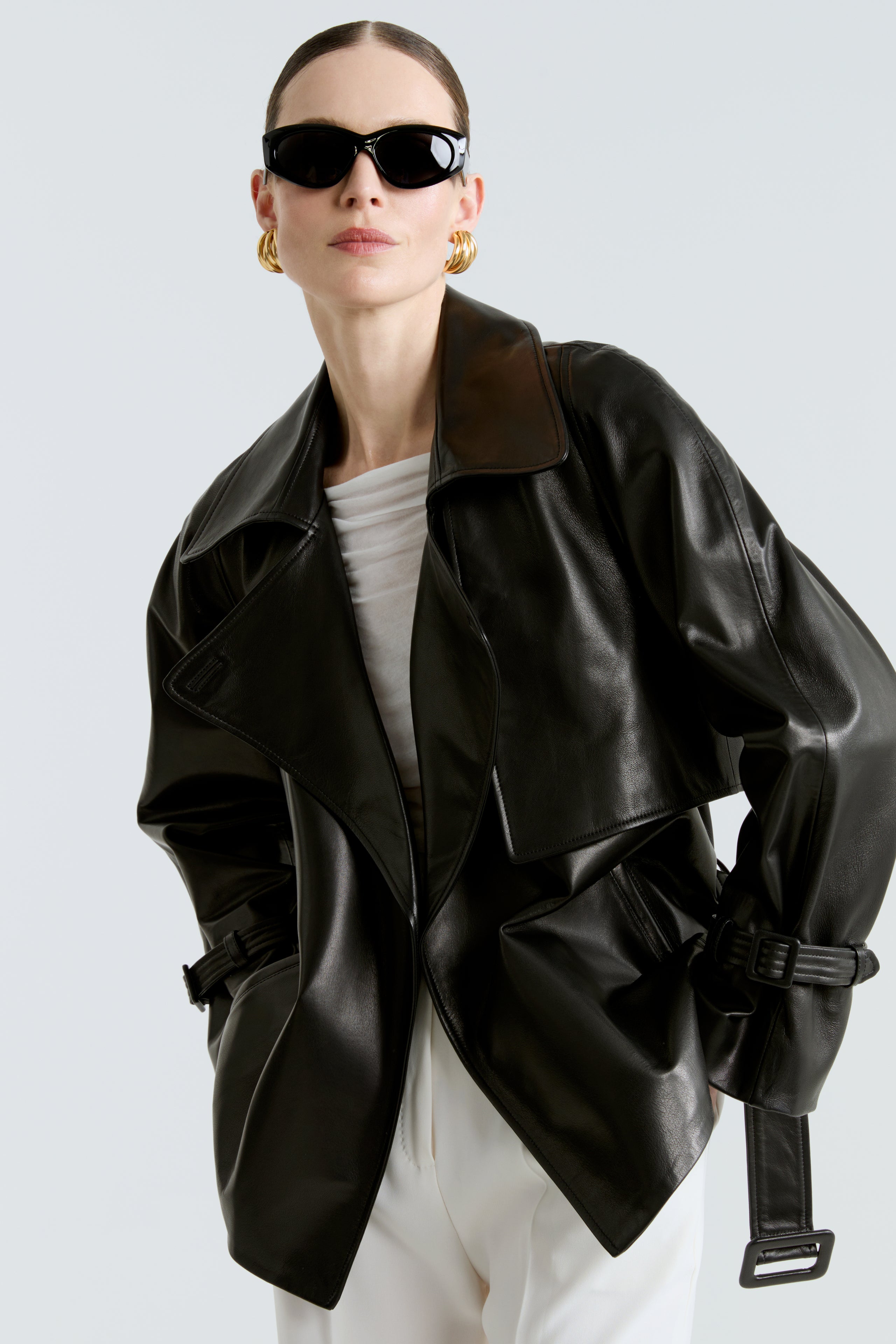 Model is wearing the Brea Black Belted Leather Short Trench Close Up