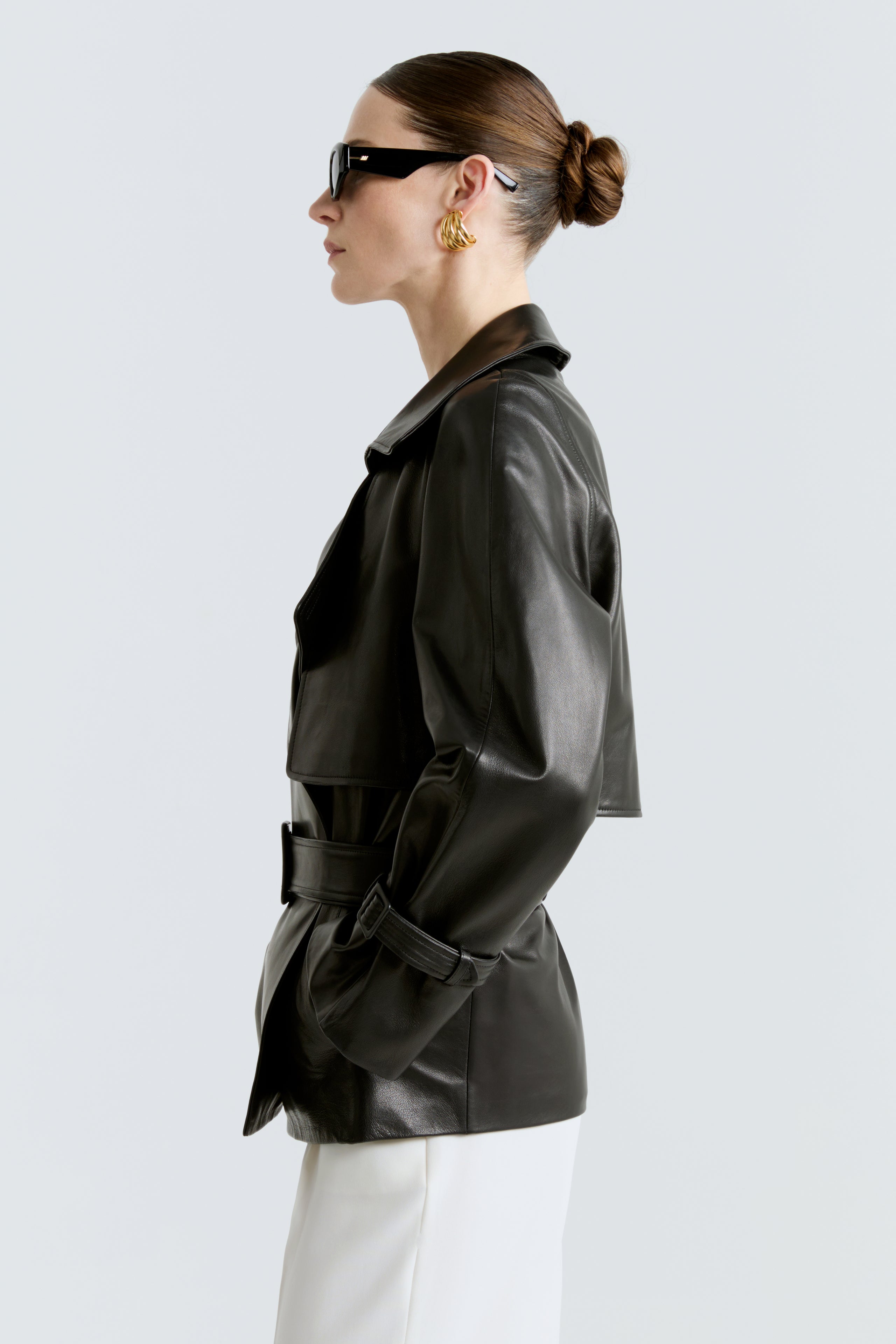 Model is wearing the Brea Black Belted Leather Short Trench Side