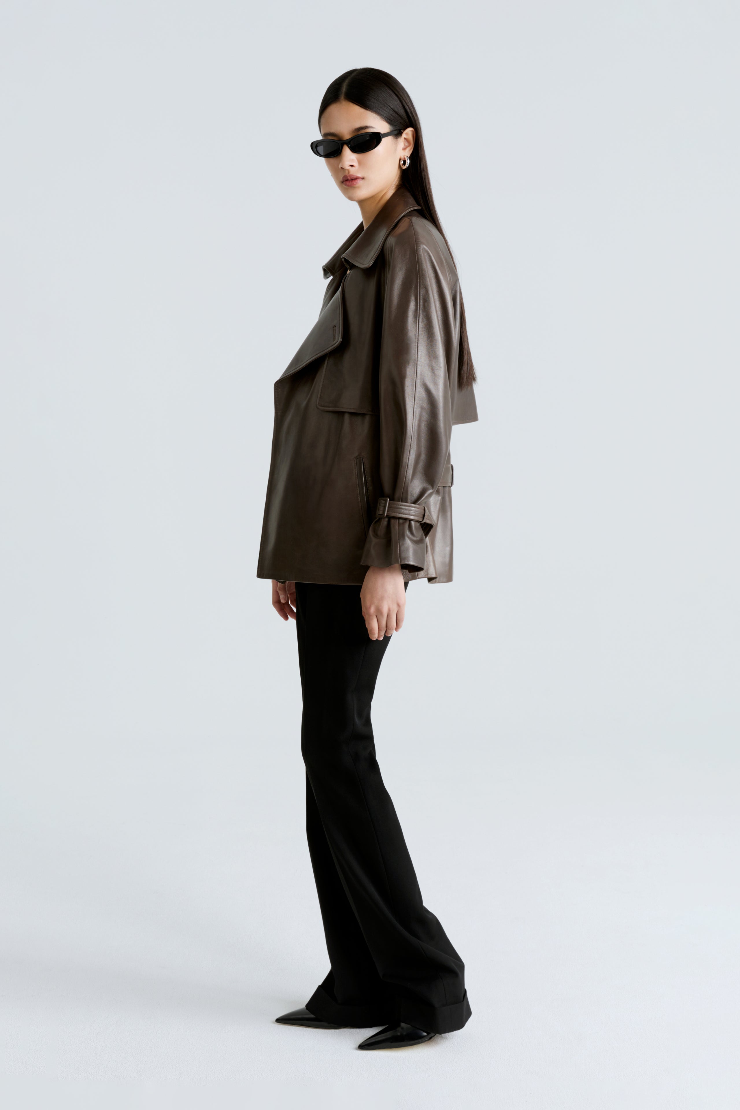 Model is wearing the Brea Truffle Belted Leather Short Trench Side