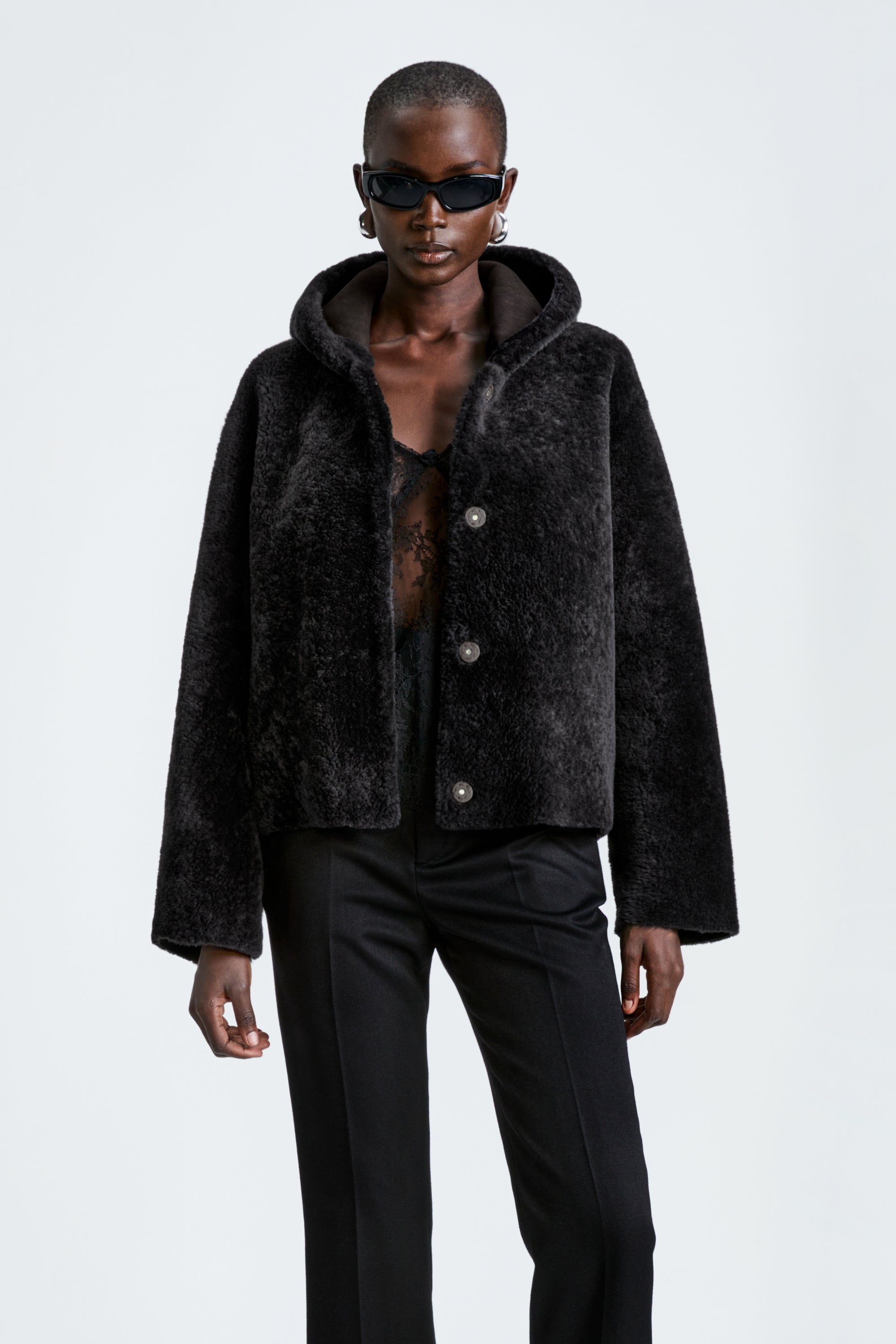 Model is wearing the Nour Hammour Cooper Coal - Hooded Shearling Coat - Close Up