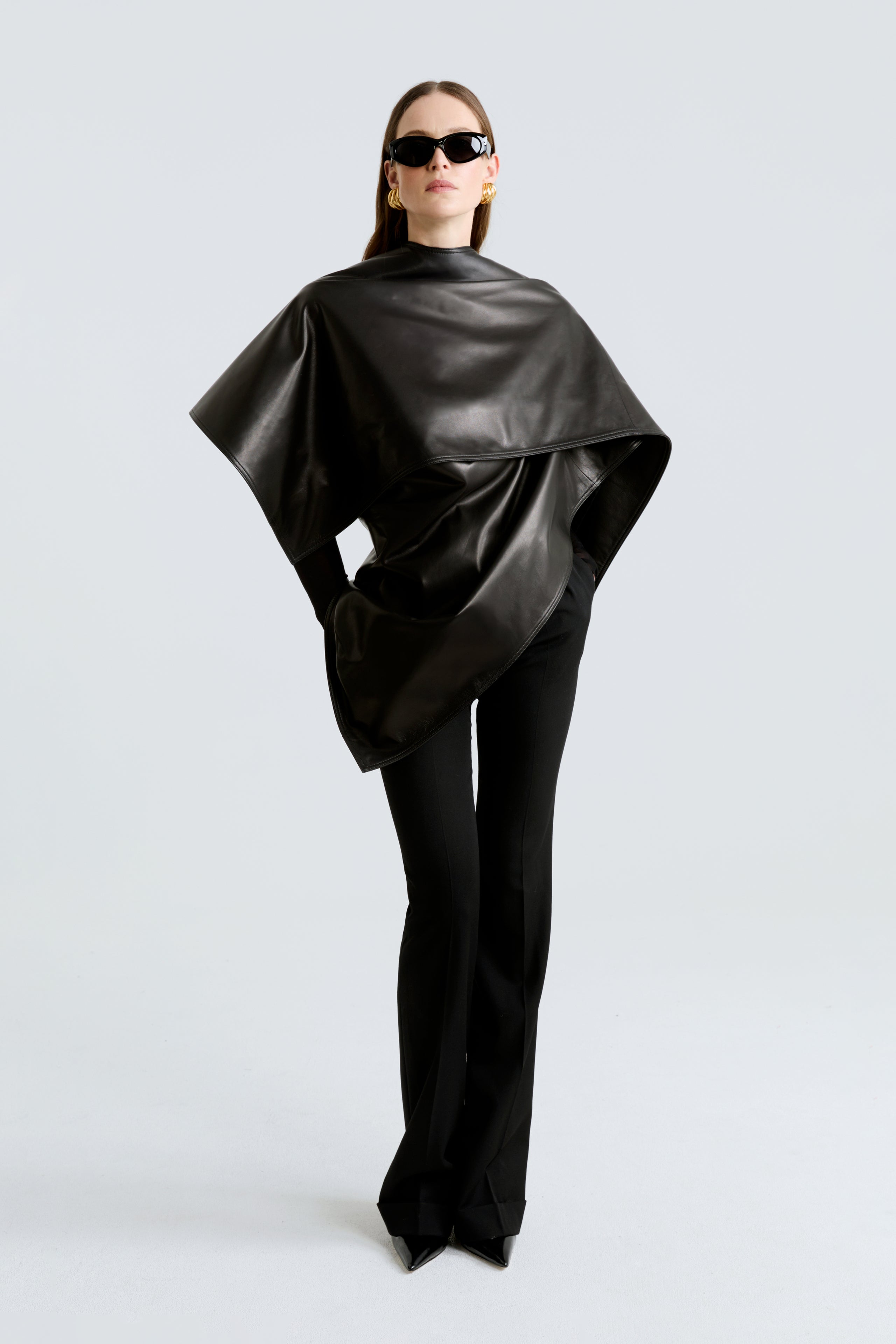 Model is wearing the Edra Black Sleek Leather Cape Front