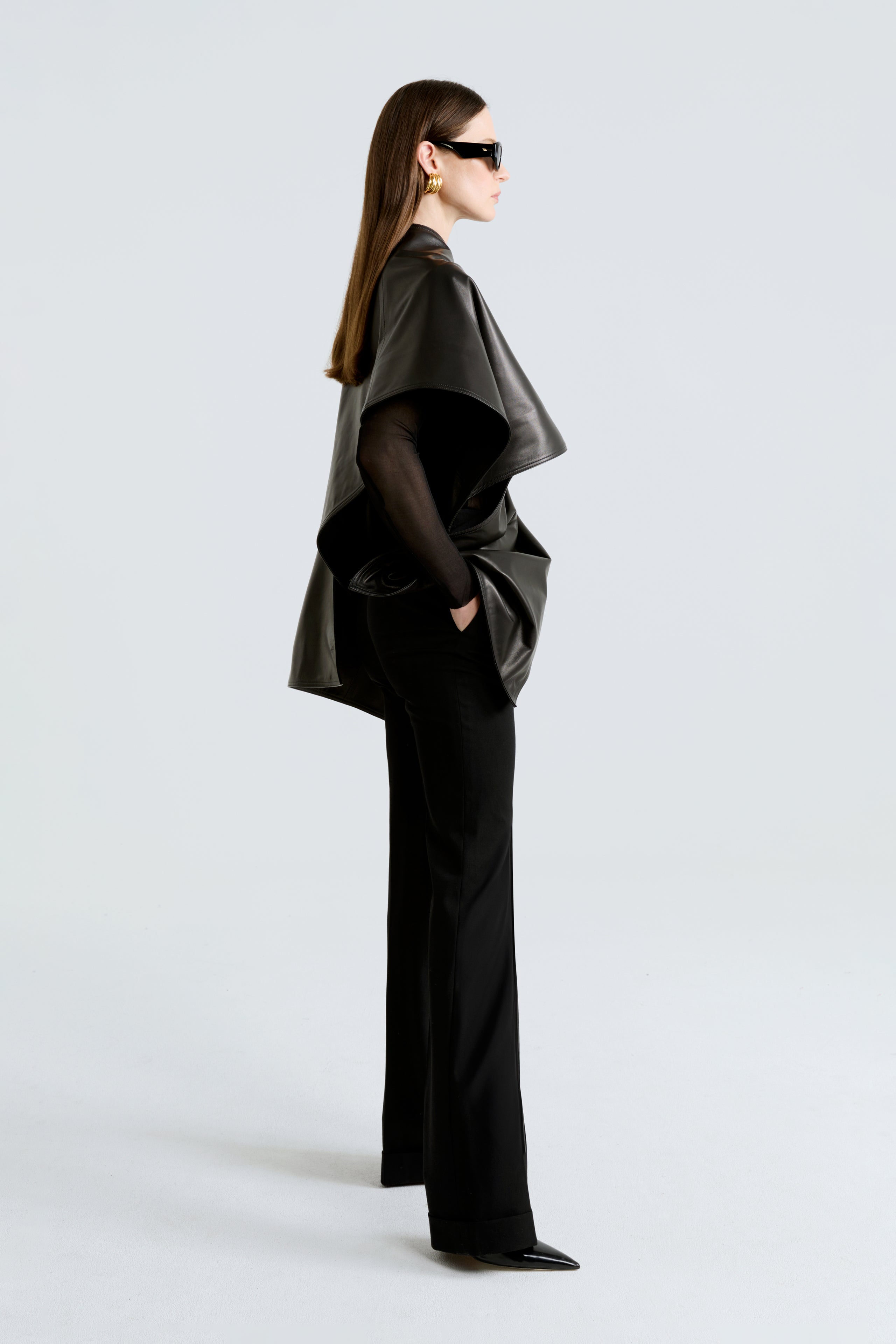 Model is wearing the Edra Black Sleek Leather Cape Side