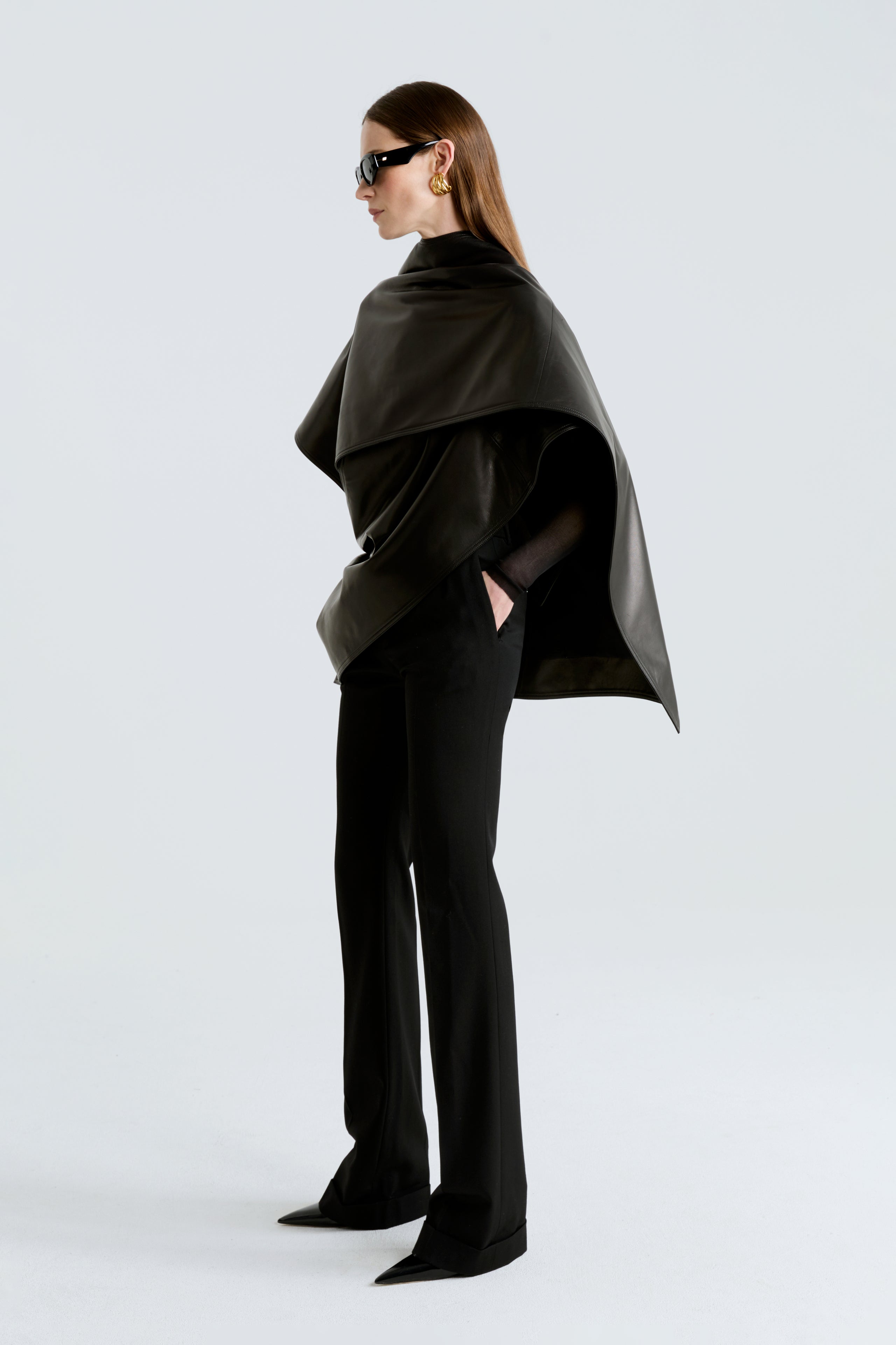 Model is wearing the Edra Black Sleek Leather Cape Side