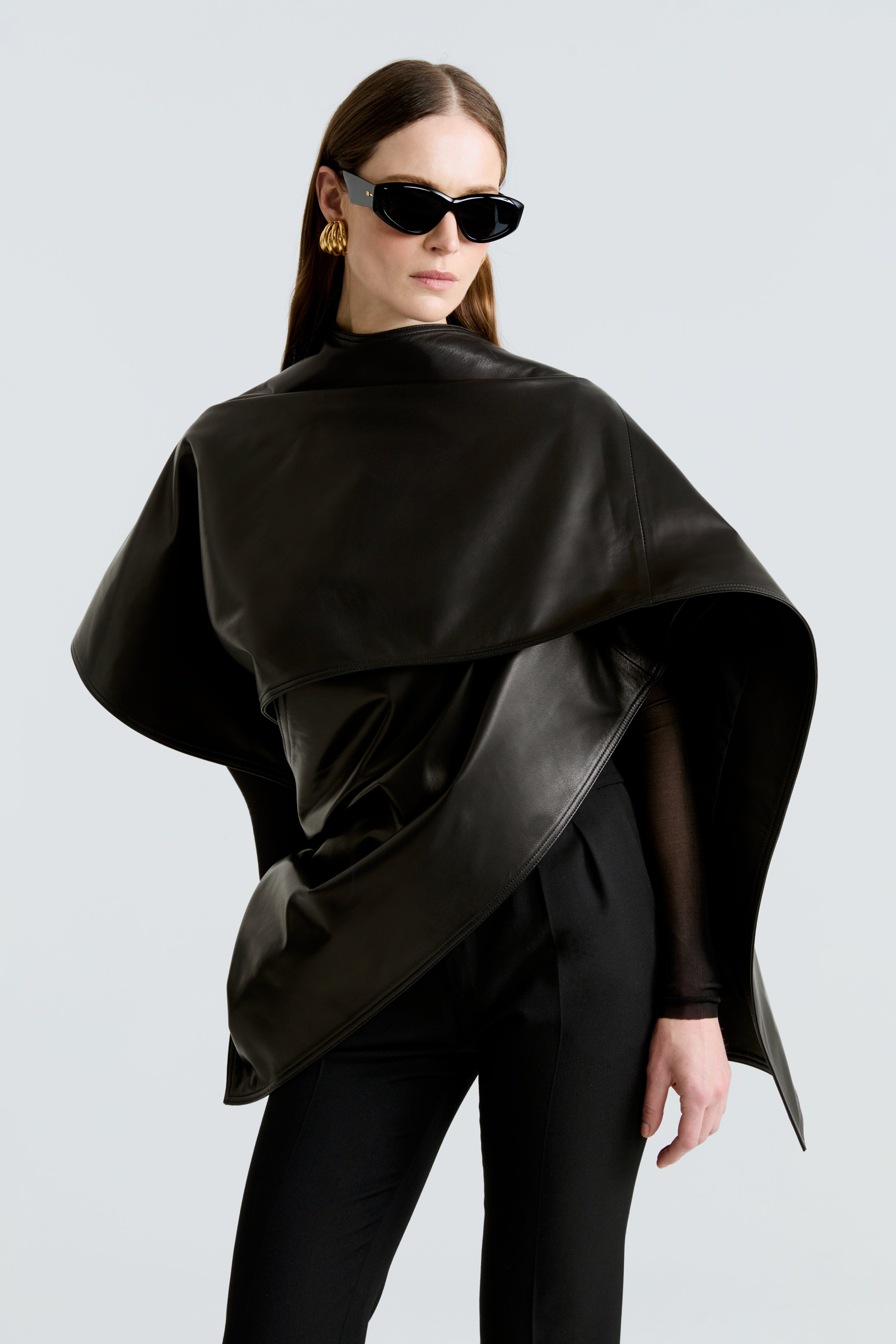 Model is wearing the Edra Black Sleek Leather Cape Close Up