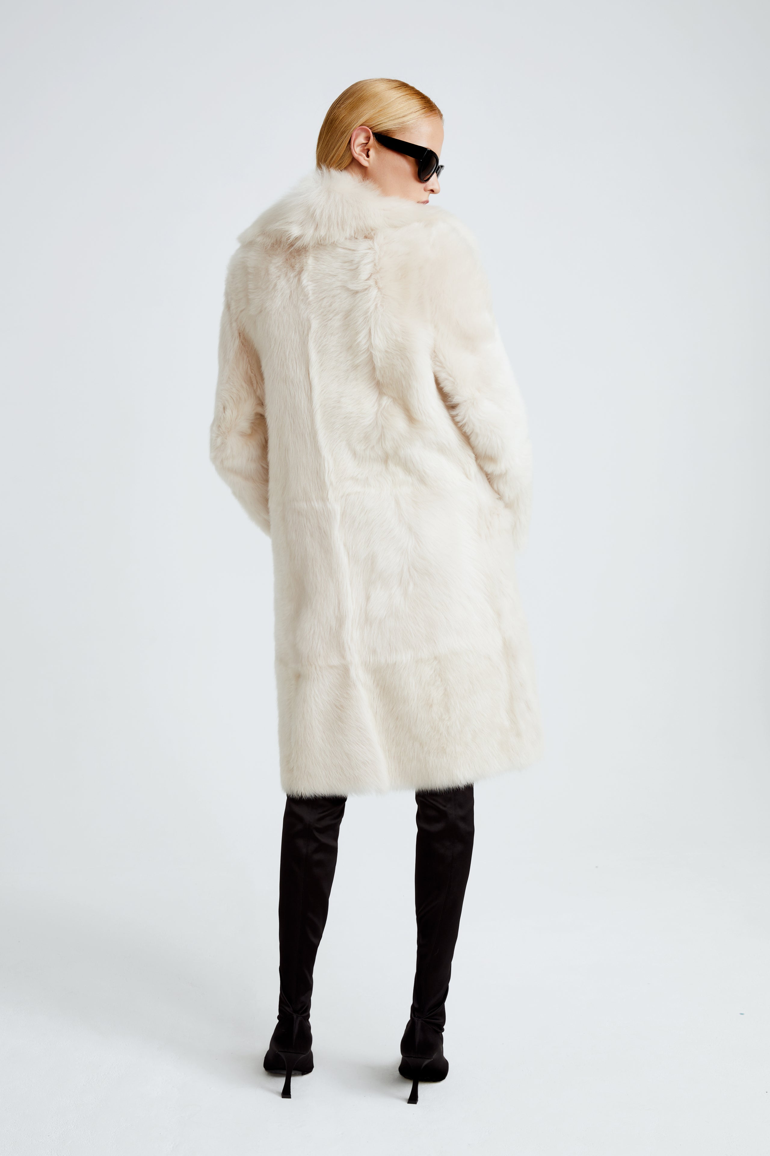 Model is wearing the Evita Cloud Après-Ski Shearling Coat Back