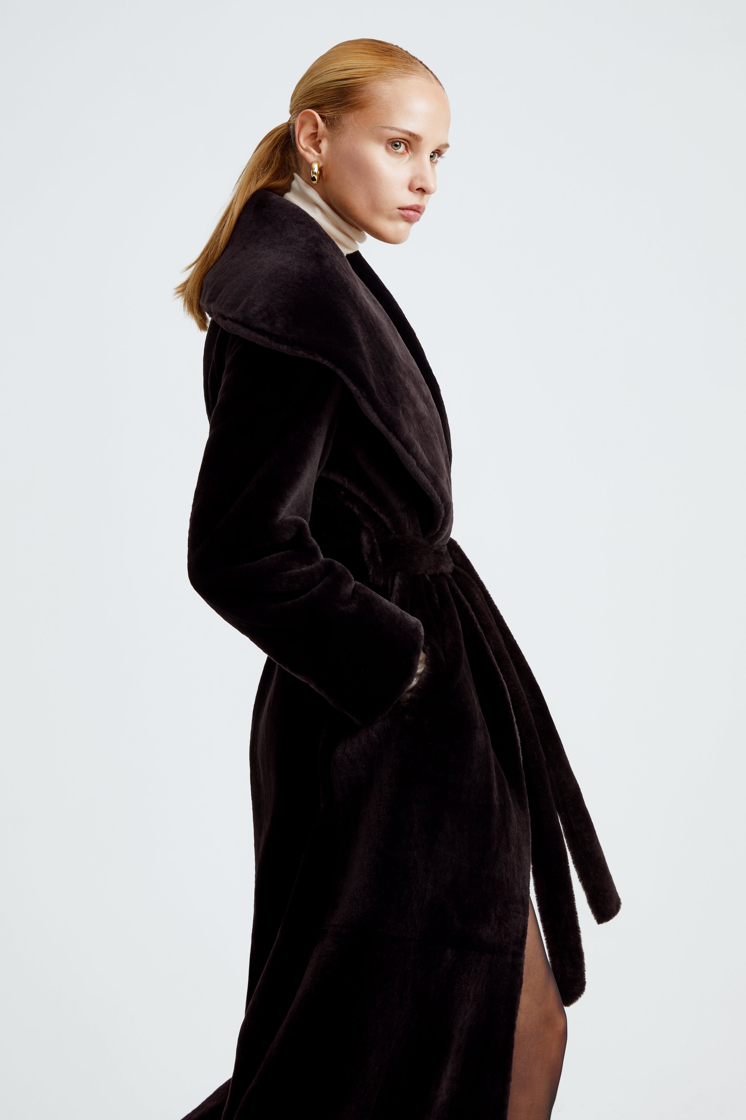 Model is wearing the Giovanna Chocolat Fondant Long Shearling Coat Close Up