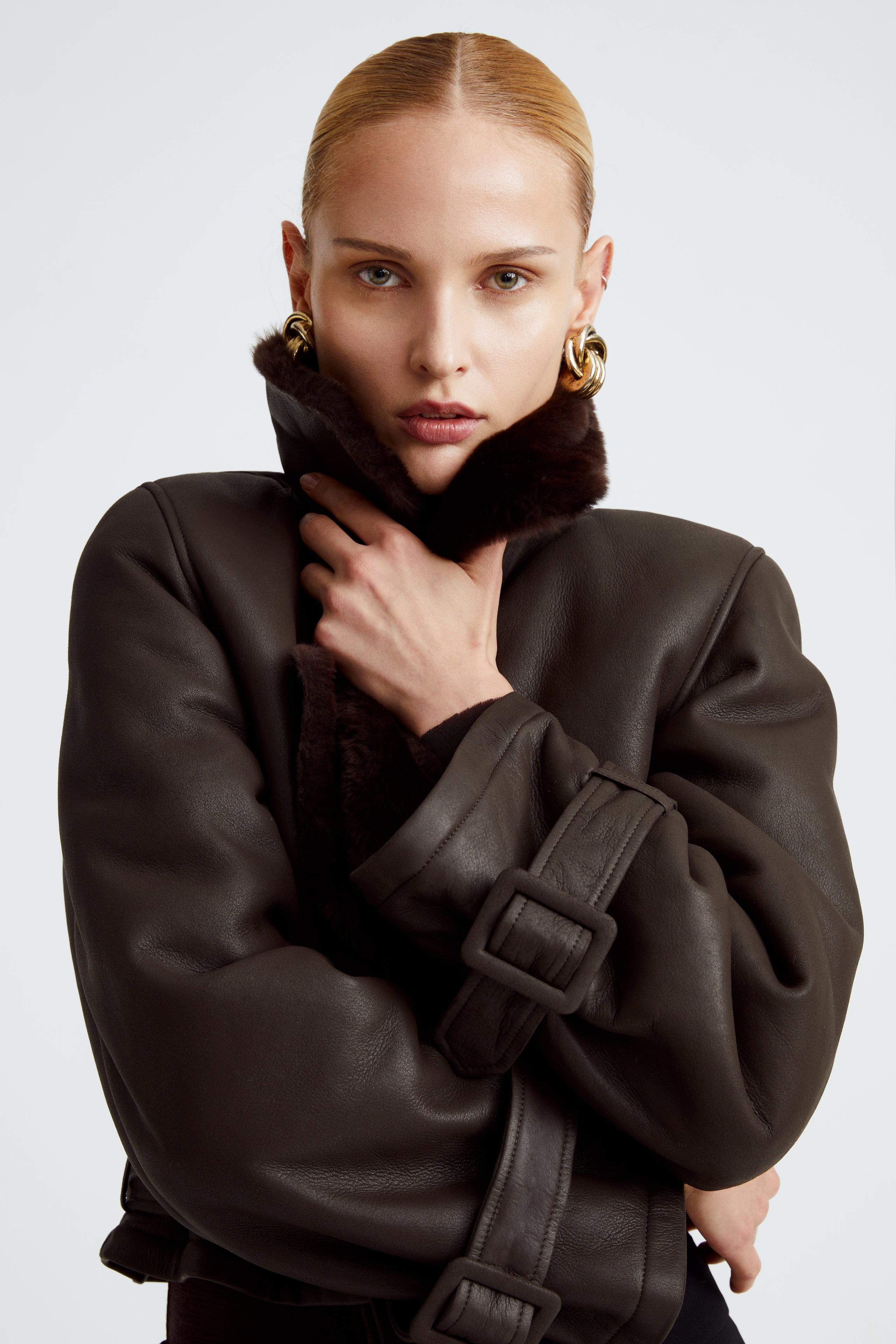 Model is wearing the Hatti Shearling Chocolat Fondant Cropped Shearling Jacket Close Up
