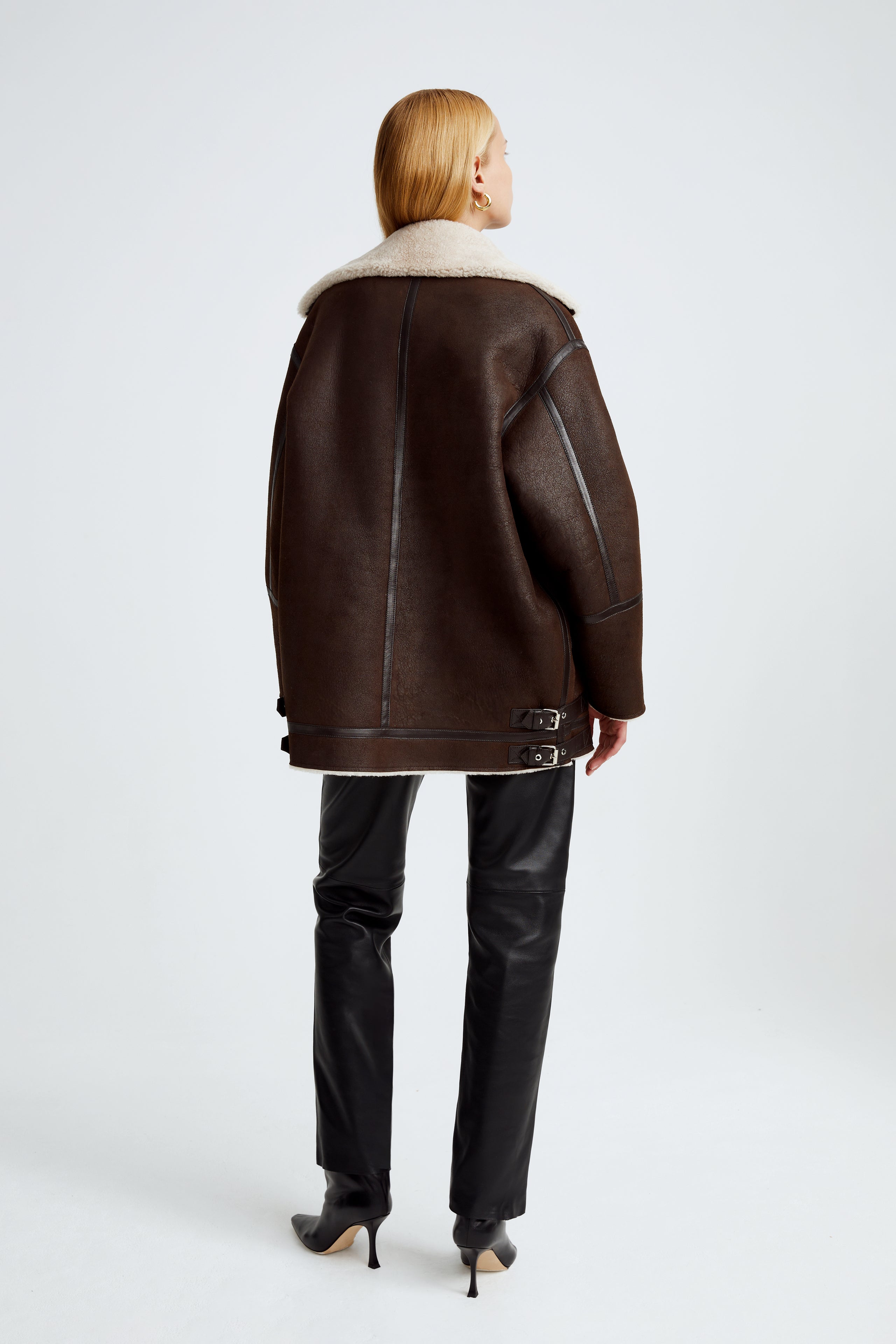 Model is wearing the Horizon Chocolat Fondant Cream Shearling Aviator Coat Back