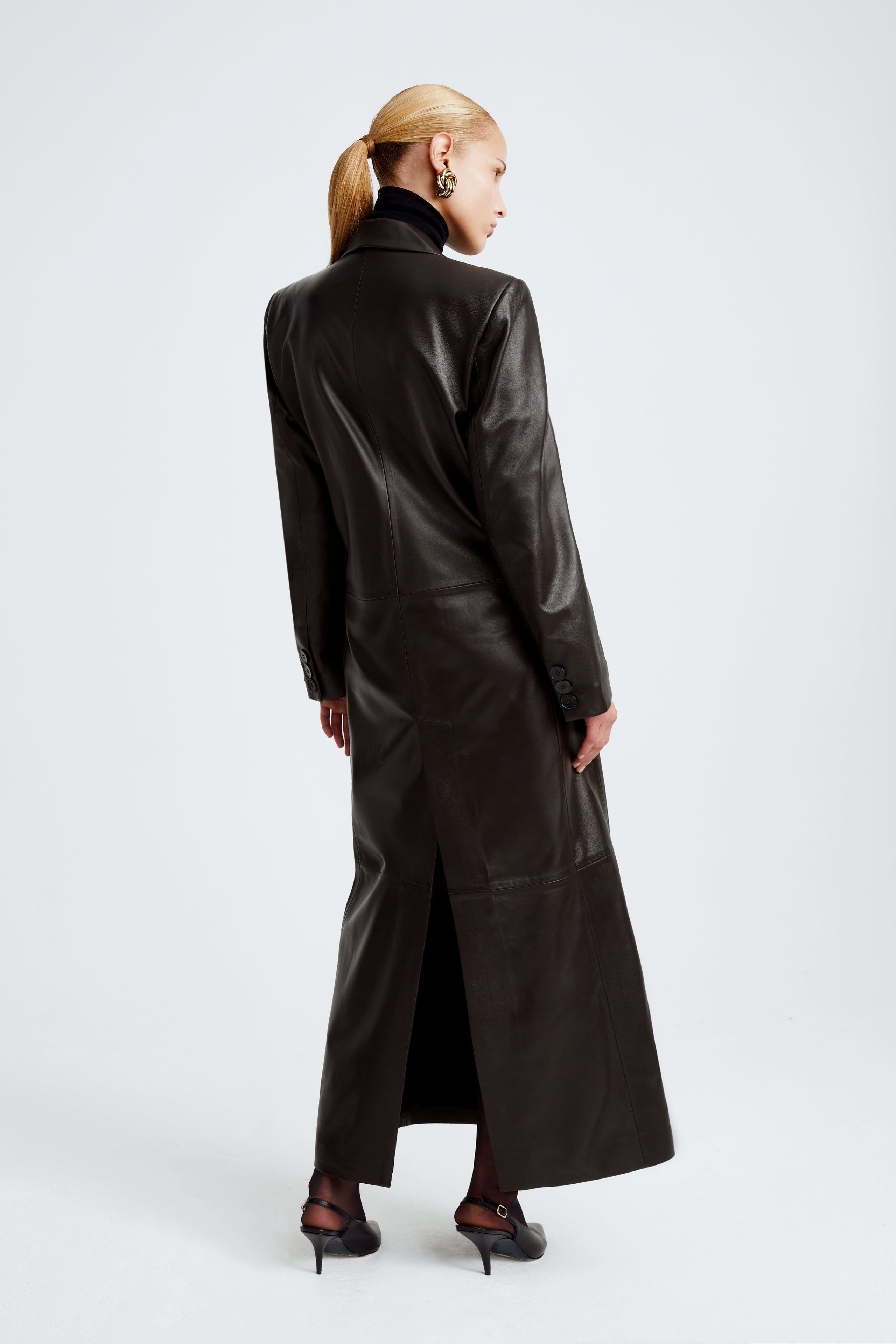 Model is wearing the Misha Chocolat Fondant Long Leather Coat Back