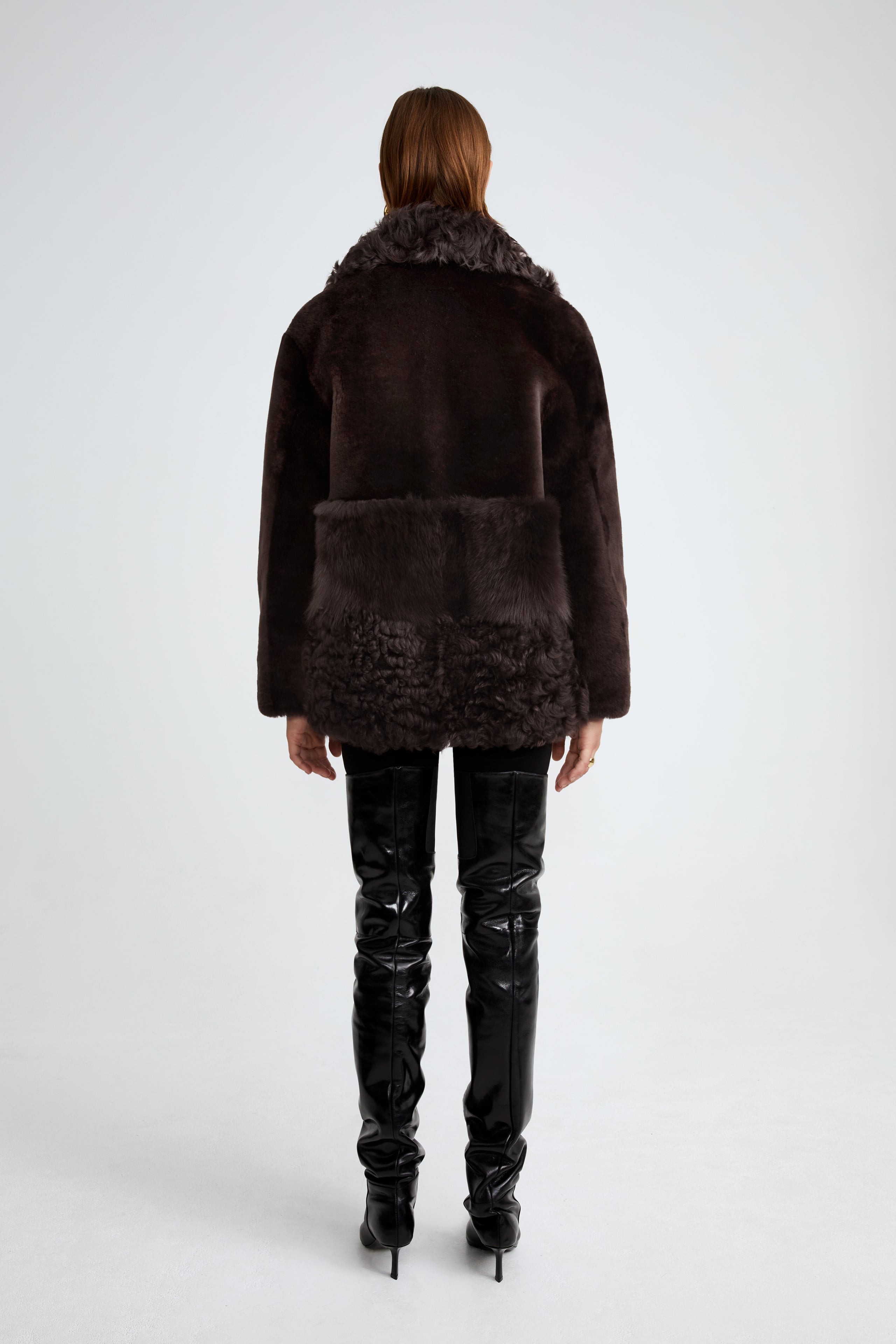 Model is wearing the Anouk Dark Chocolate Luxurious Shearling Coat Back