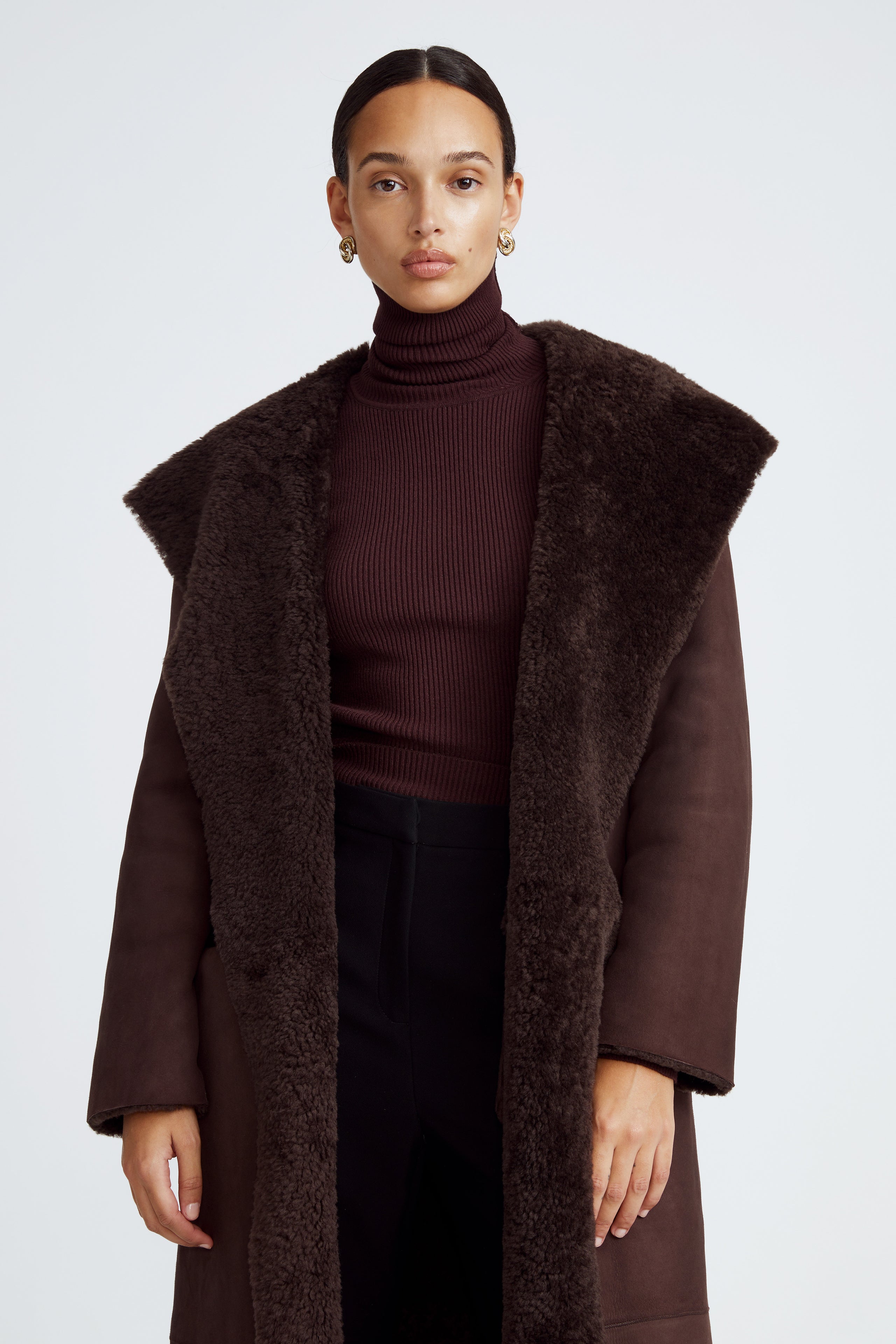 Model is wearing the Birthday Coat Dark Chocolate Draped Shearling Coat Close Up