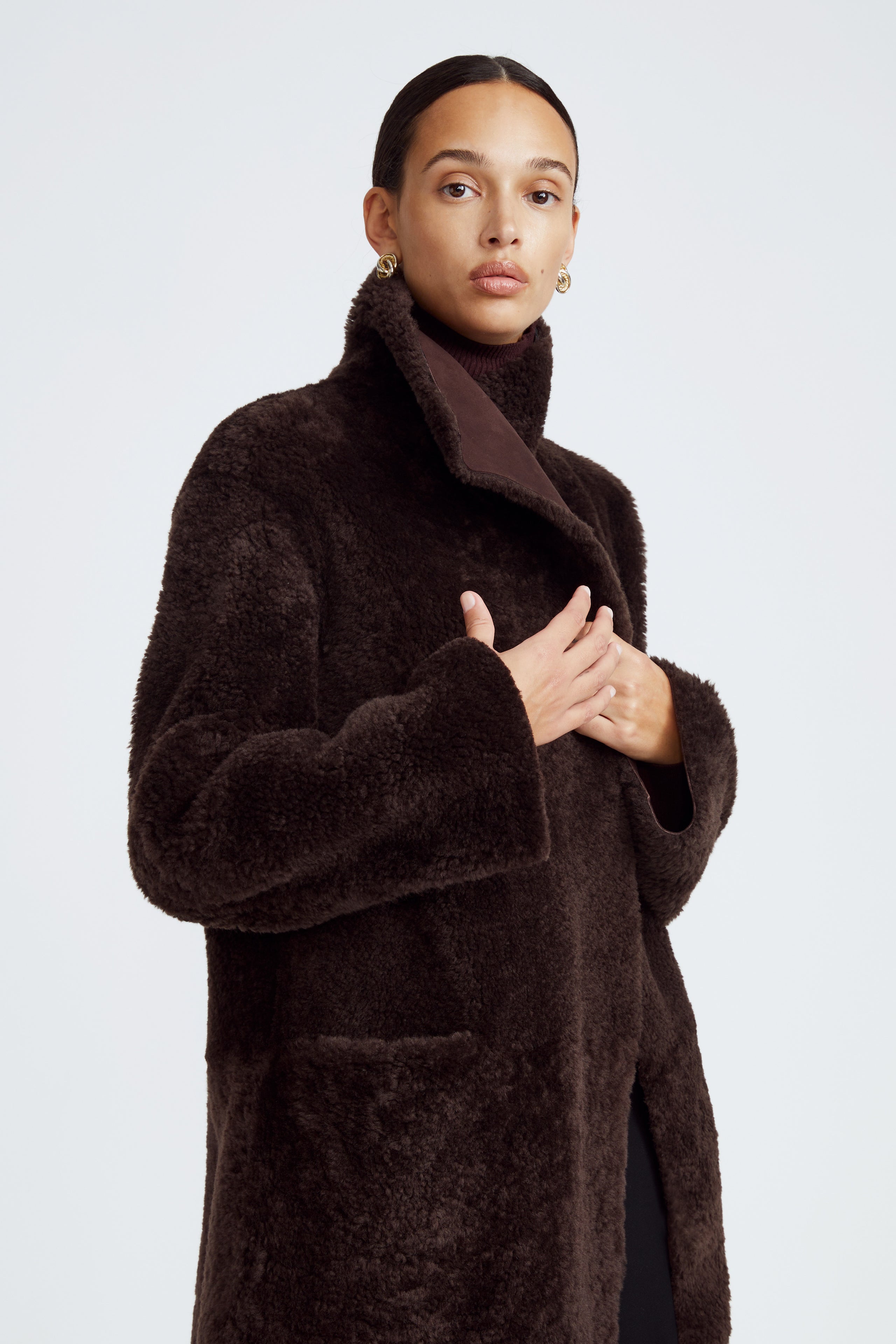 Model is wearing the Birthday Coat Dark Chocolate Draped Shearling Coat Close Up