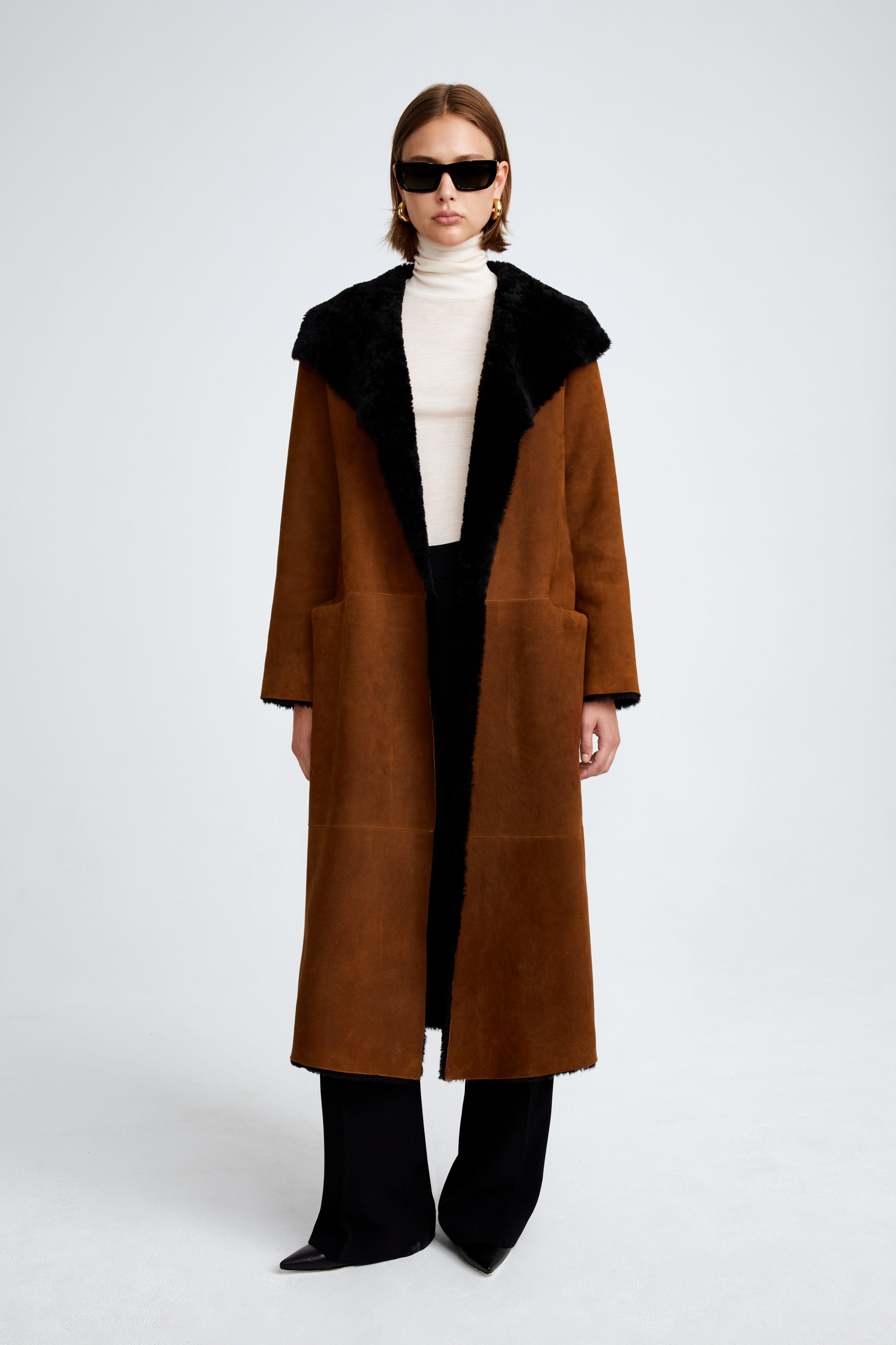 Model is wearing the Birthday Coat Cognac Black Draped Shearling Coat Front