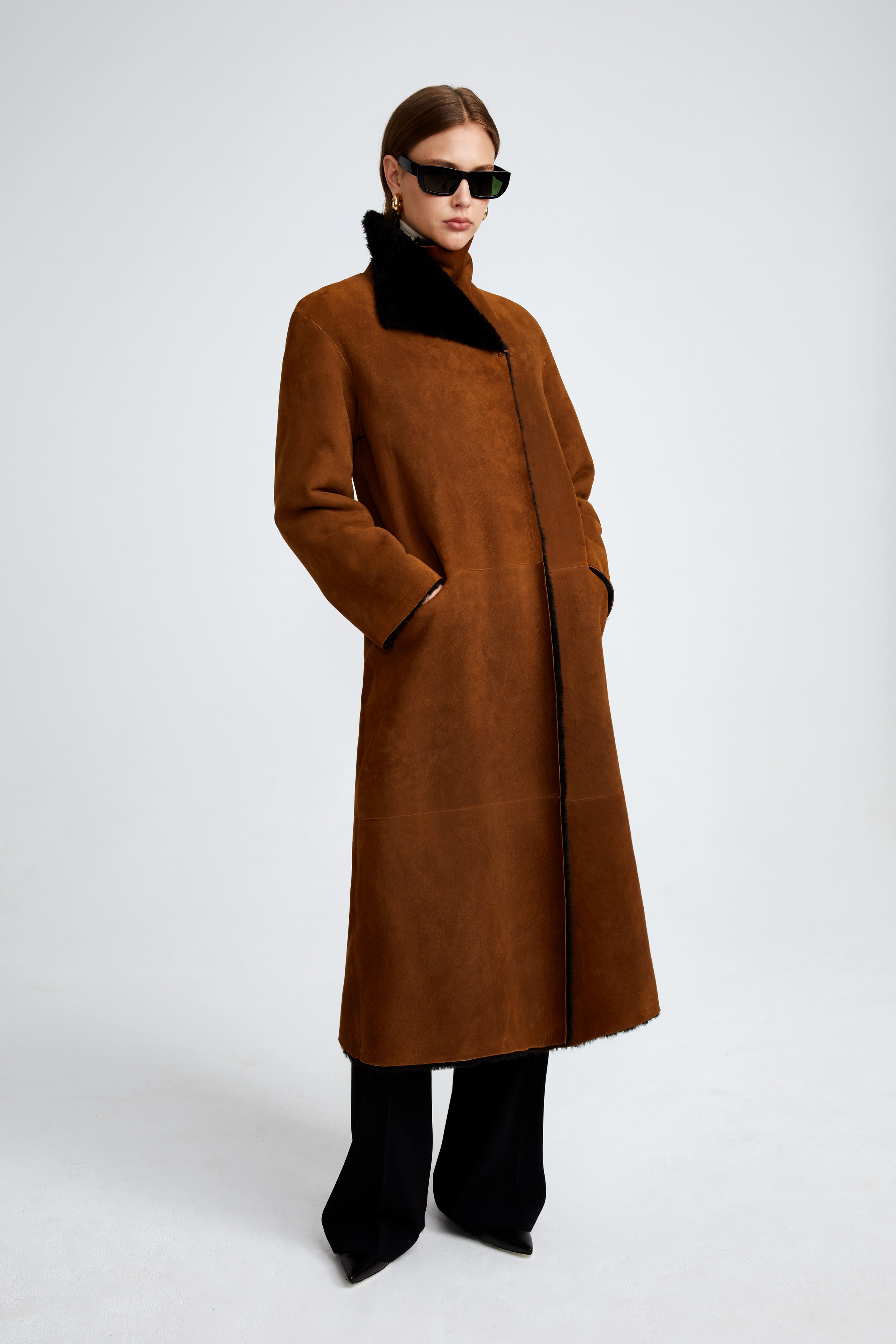 Model is wearing the Birthday Coat Cognac Black Draped Shearling Coat Front