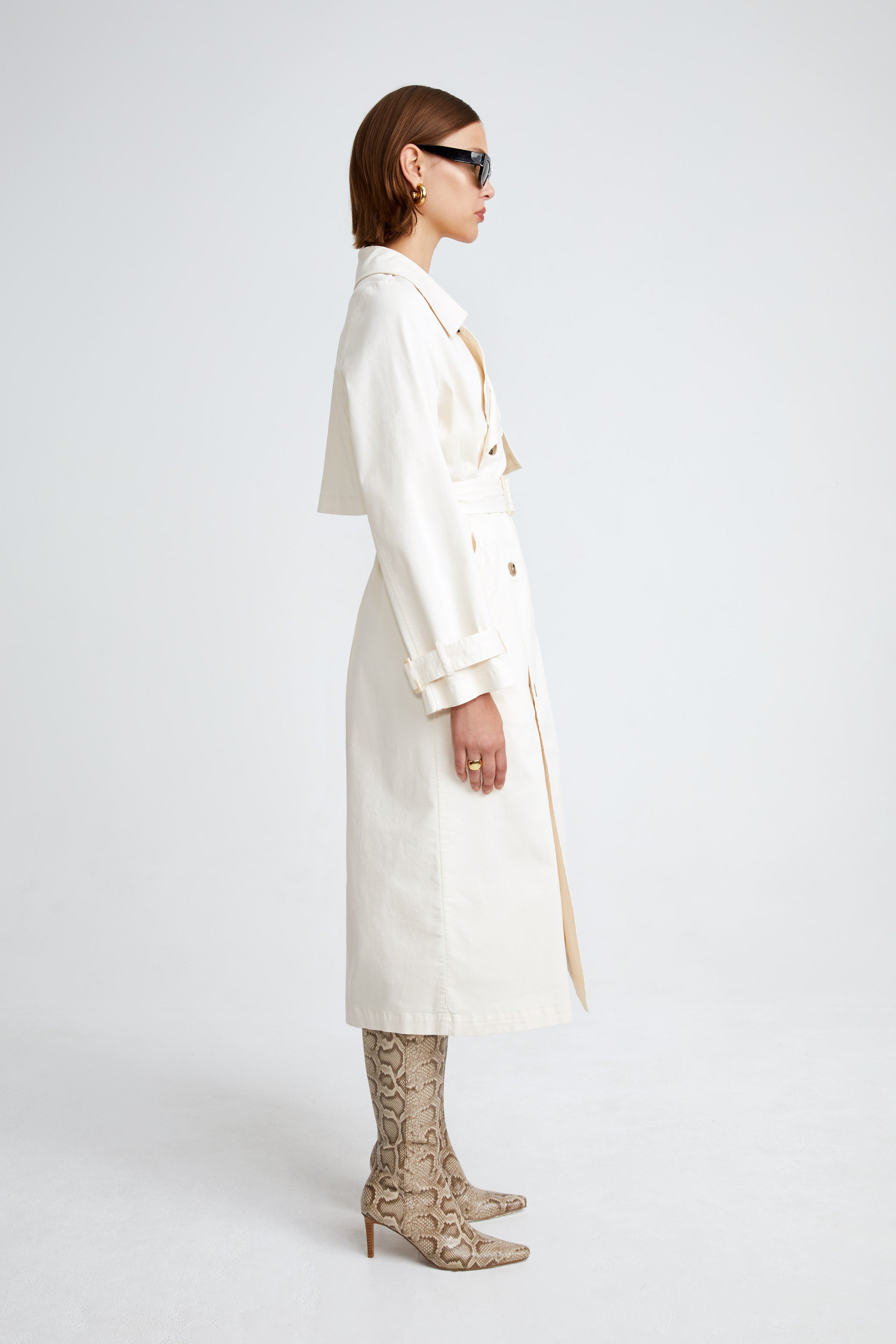 Model is wearing the Harriet Canvas Cream Long Fabric Trench Side