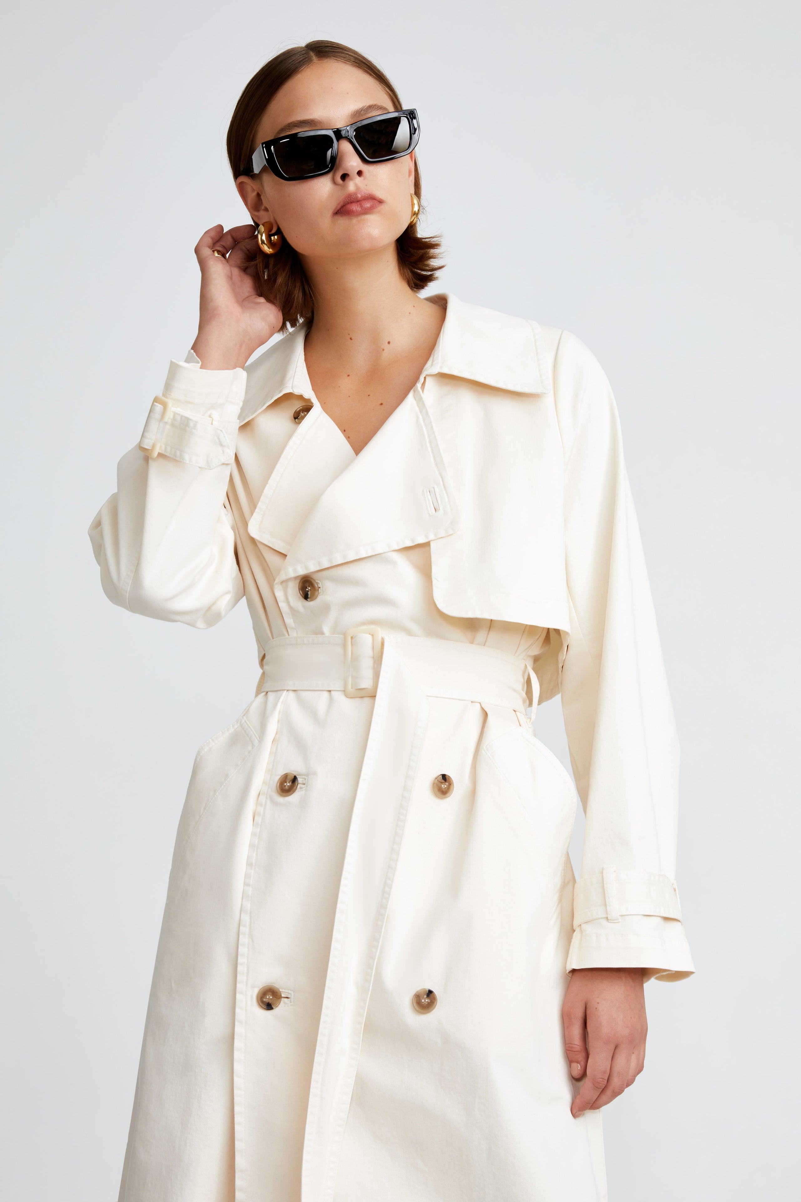 Model is wearing the Harriet Canvas Cream Long Fabric Trench Close Up