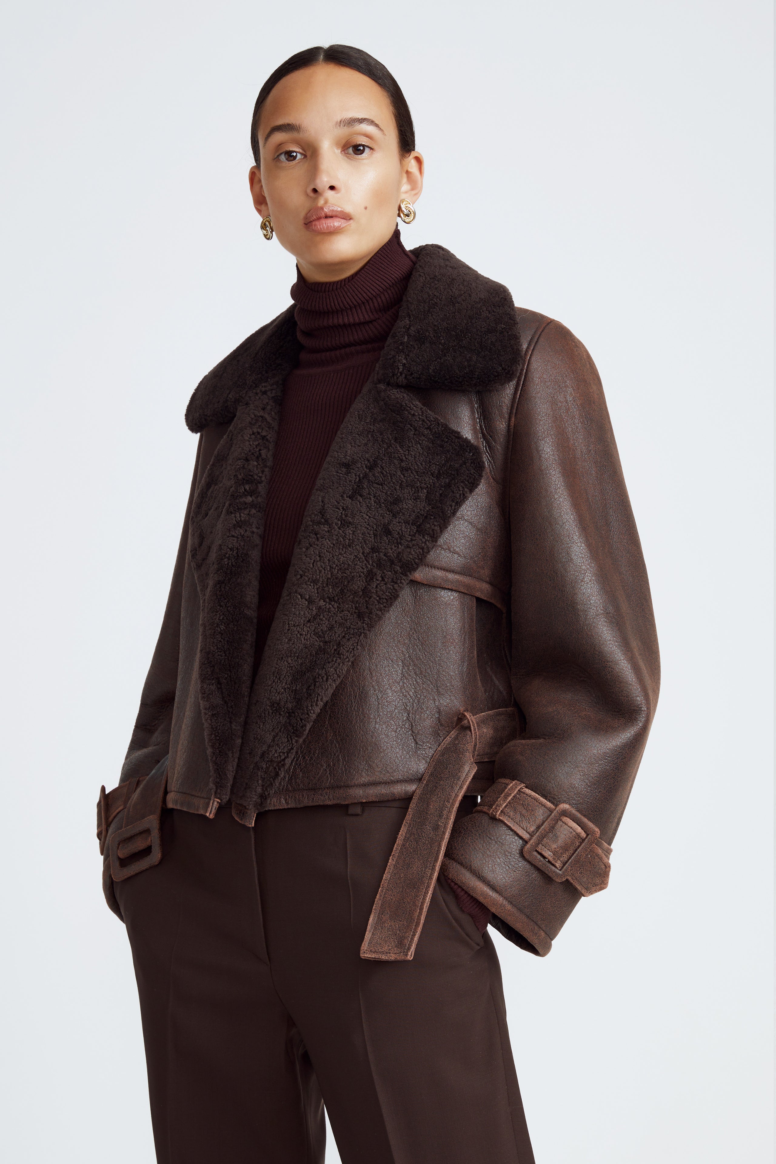 Model is wearing the Hatti Shearling Dark Chocolate Cropped Shearling Jacket Close Up