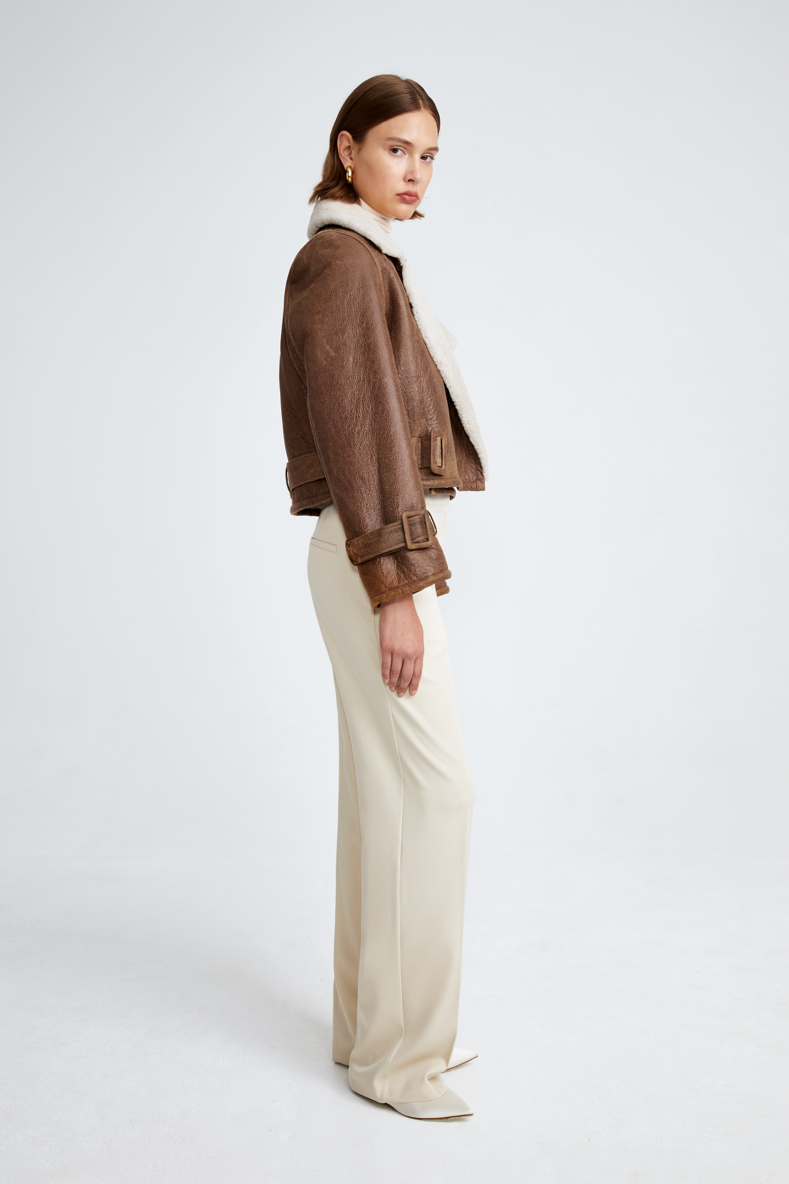 Model is wearing the Hatti Shearling Camel Ivory Cropped Shearling Jacket Side