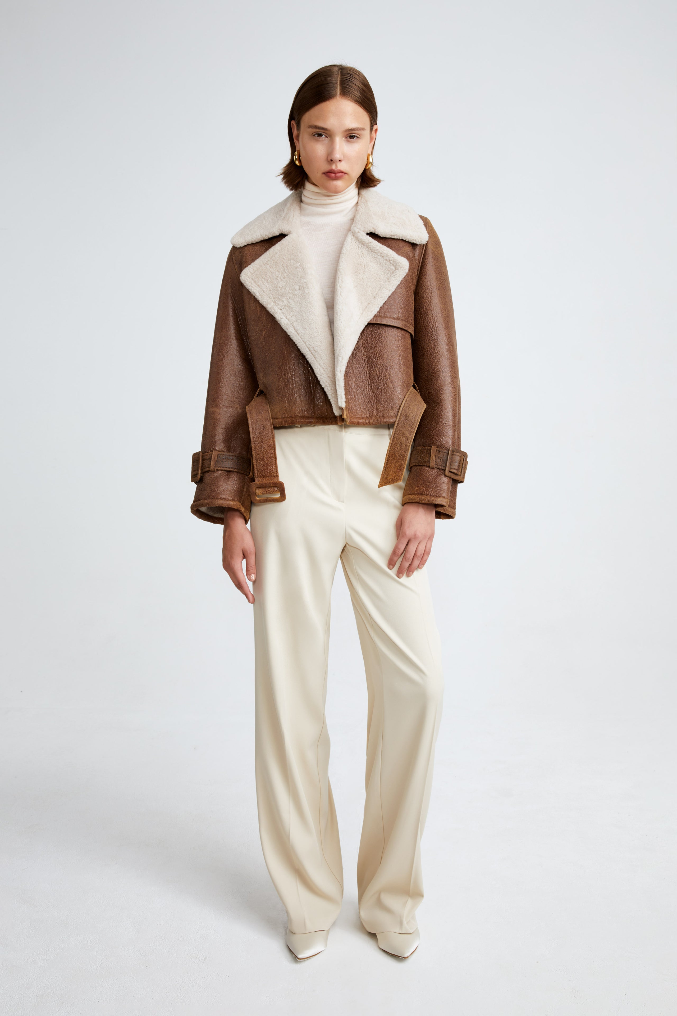 Model is wearing the Hatti Shearling Camel Ivory Cropped Shearling Jacket Front