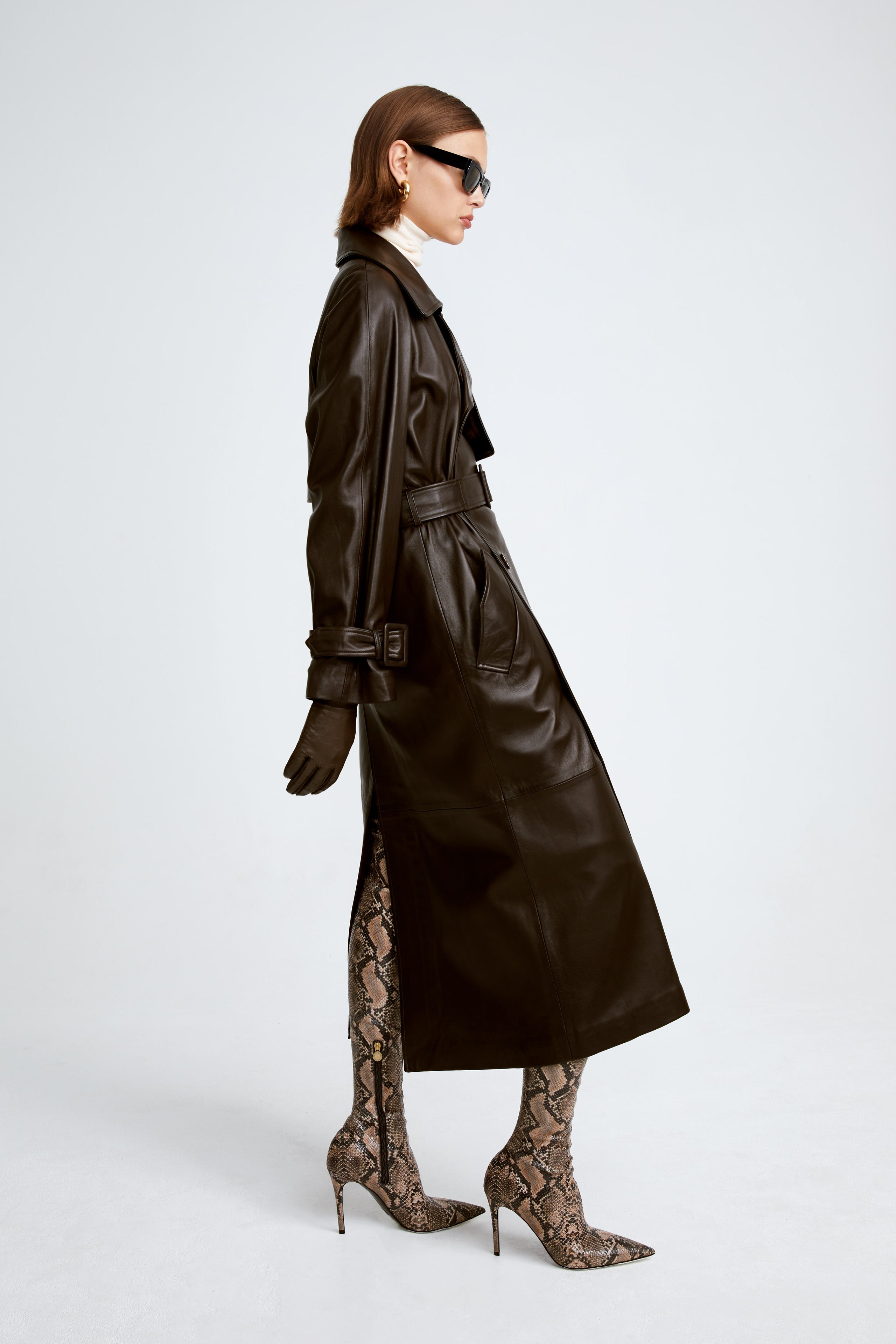 Model is wearing Nour Hammour's Henri Brown Leather Trench Coat - Side