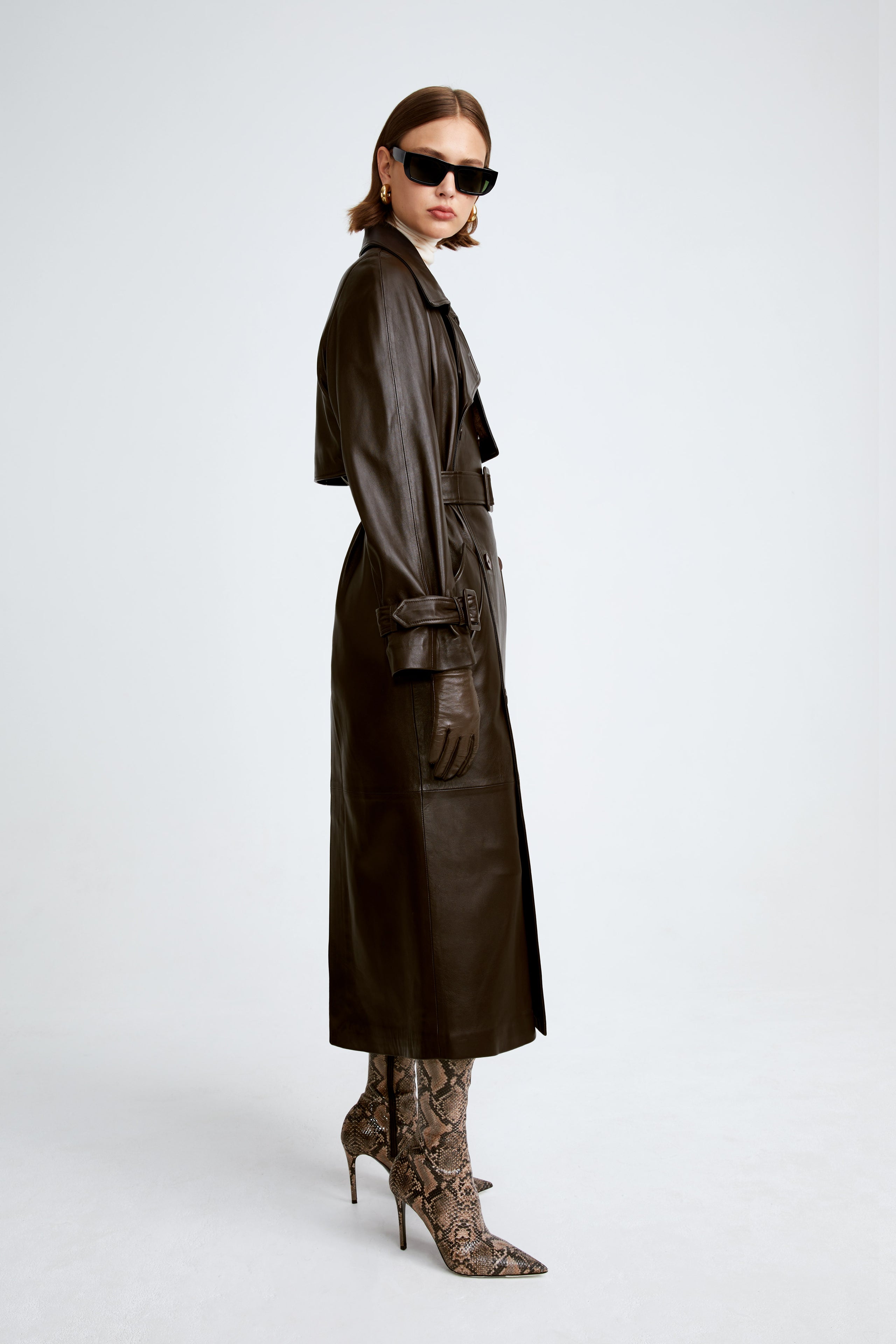 Model is wearing the Henri Umber Leather Trench Coat Side