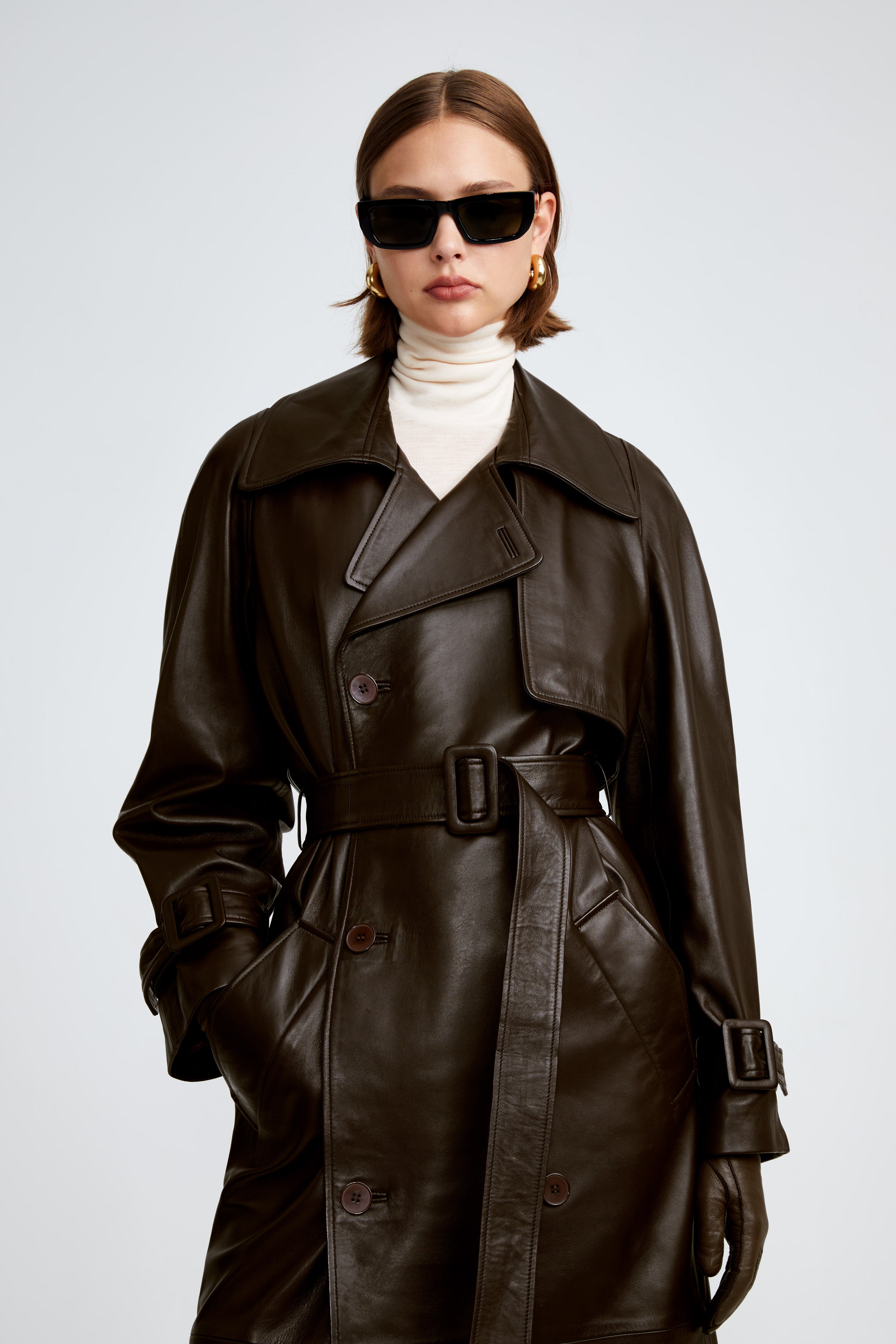 Model is wearing the Henri Umber Leather Trench Coat Close Up