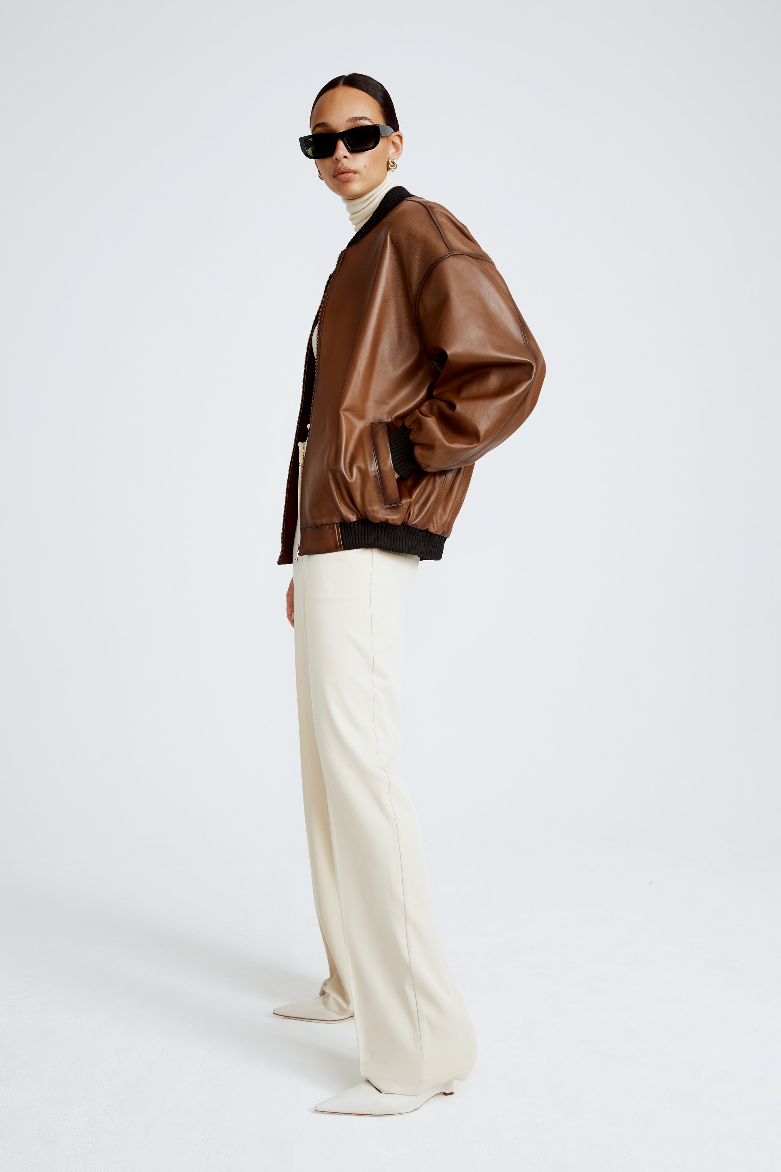 Model is wearing the Marly Brown Leather Bomber Jacket Side