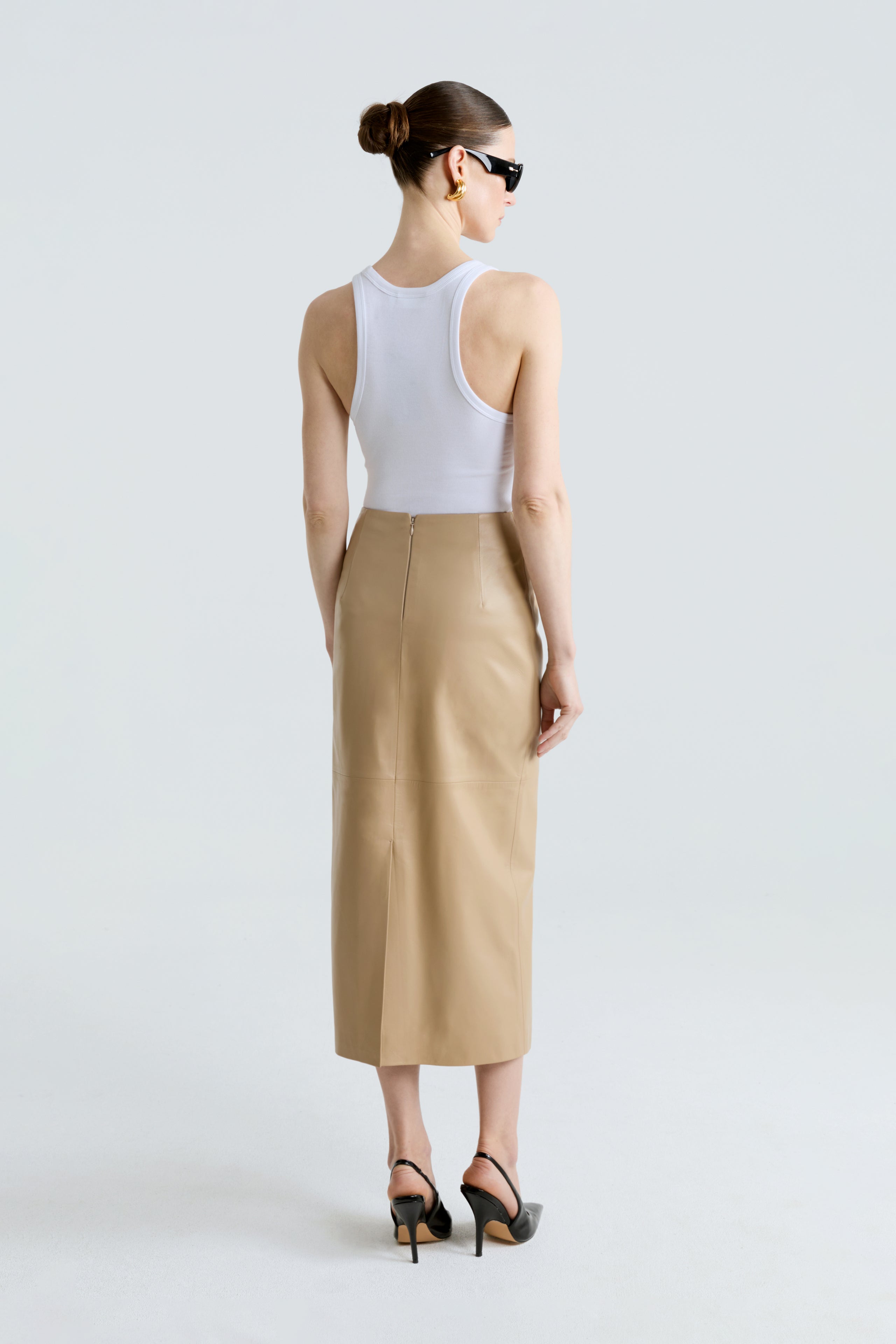 Model is wearing the Selly Skirt Beige Pencil Leather Skirt Back