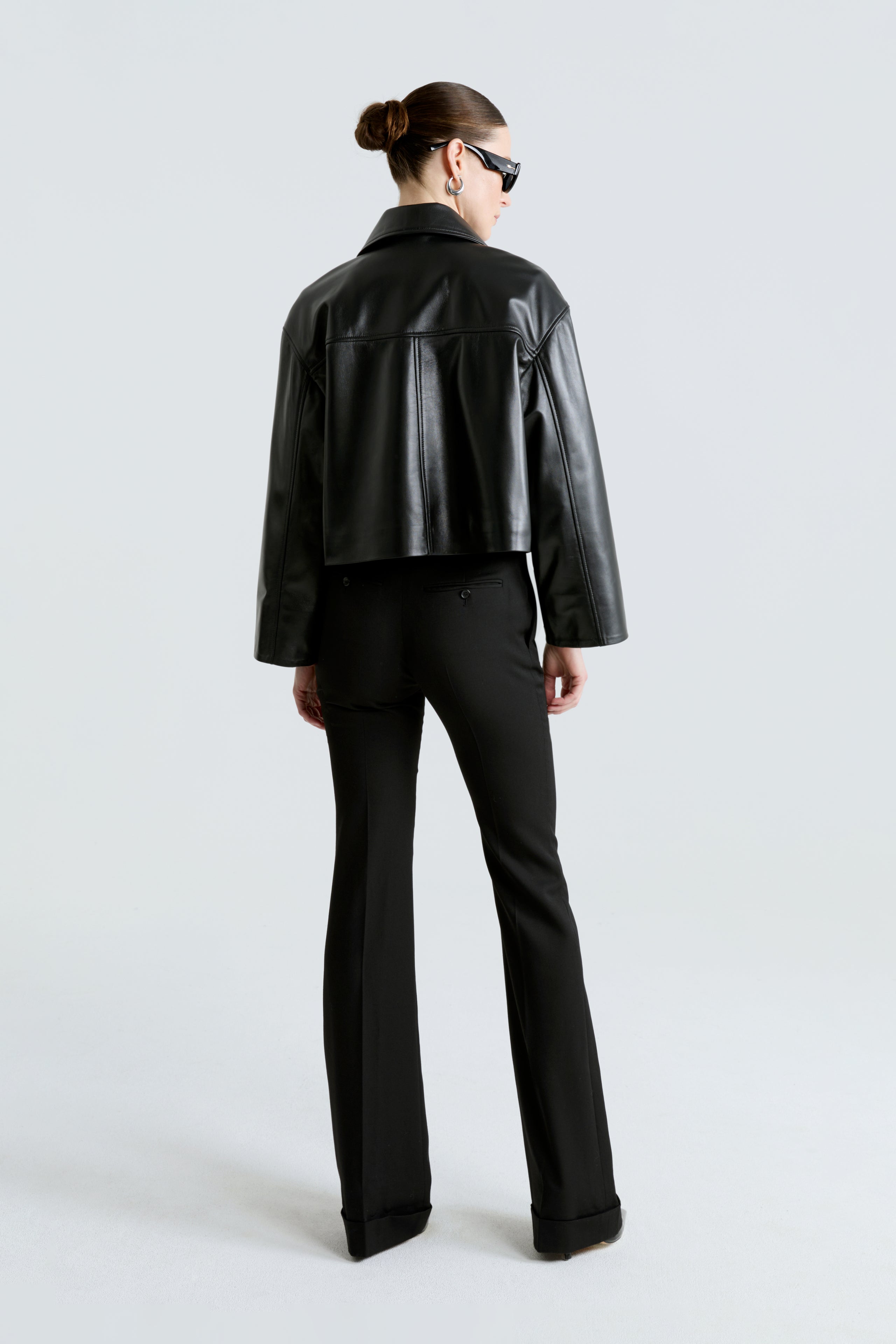 Model is wearing the Sloan Black Minimalist Leather Jacket Back