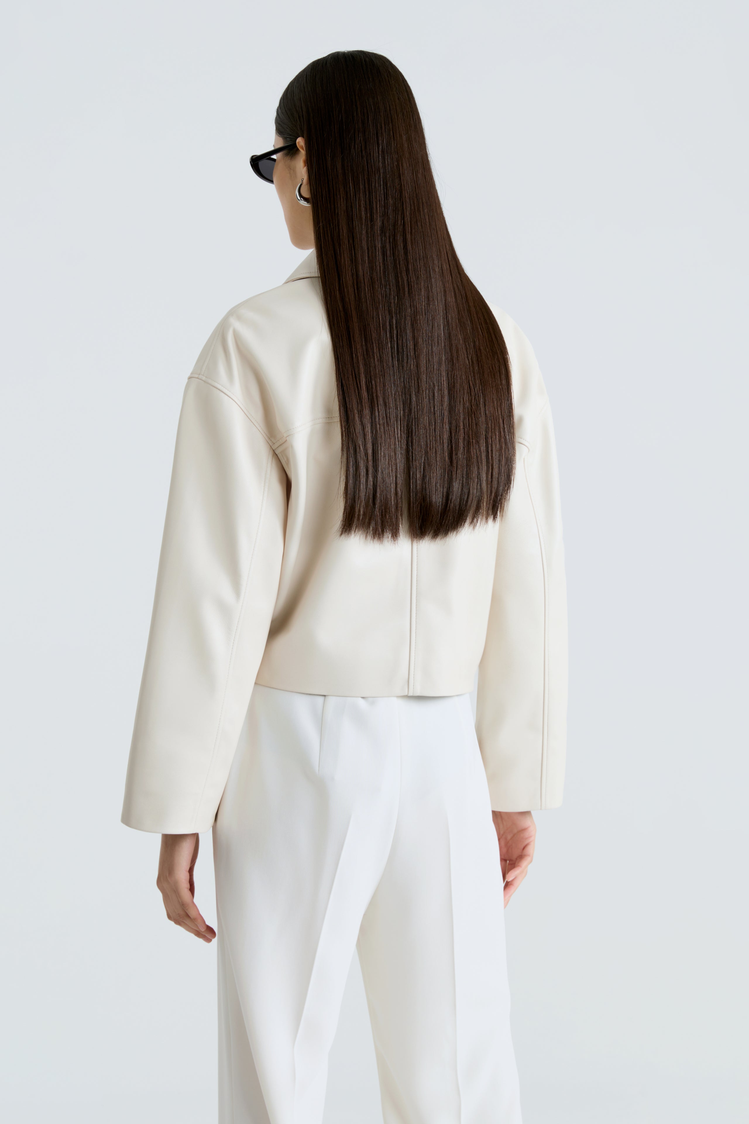 Model is wearing The Nour Hammour Sloan Ivory Minimalist Leather Jacket Back