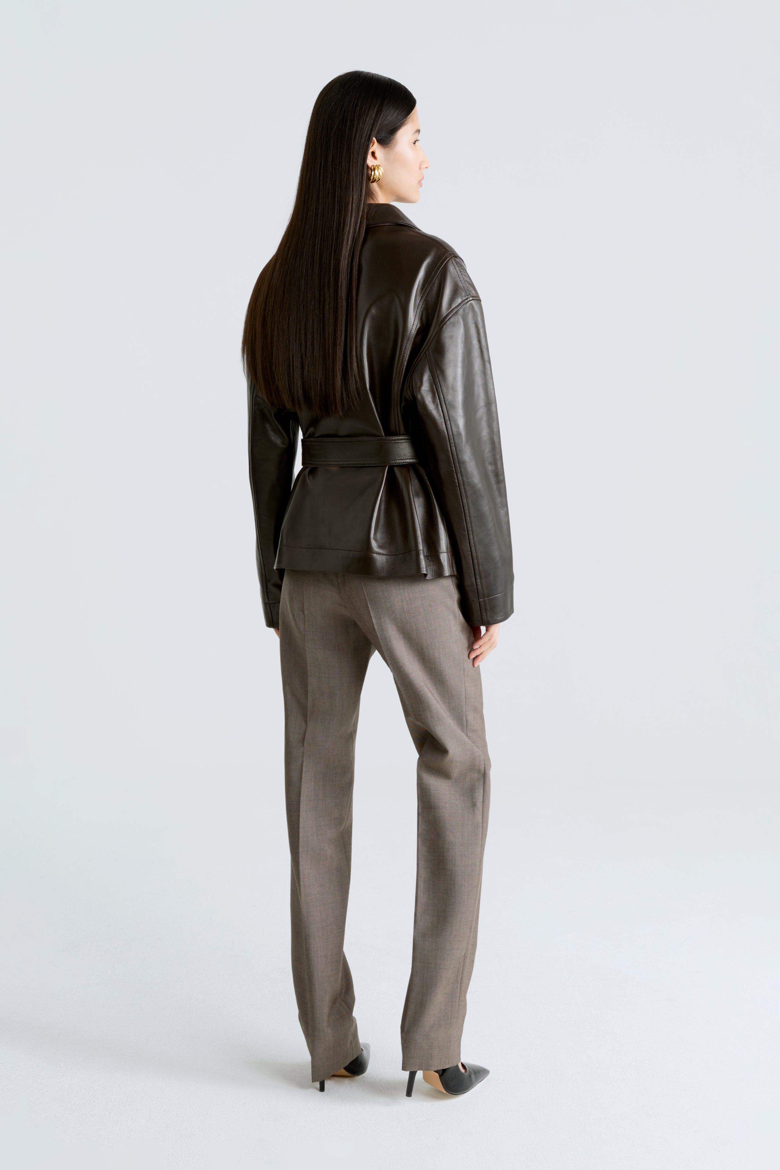 Model is wearing the Tilda Syrup Belted Leather Jacket Back
