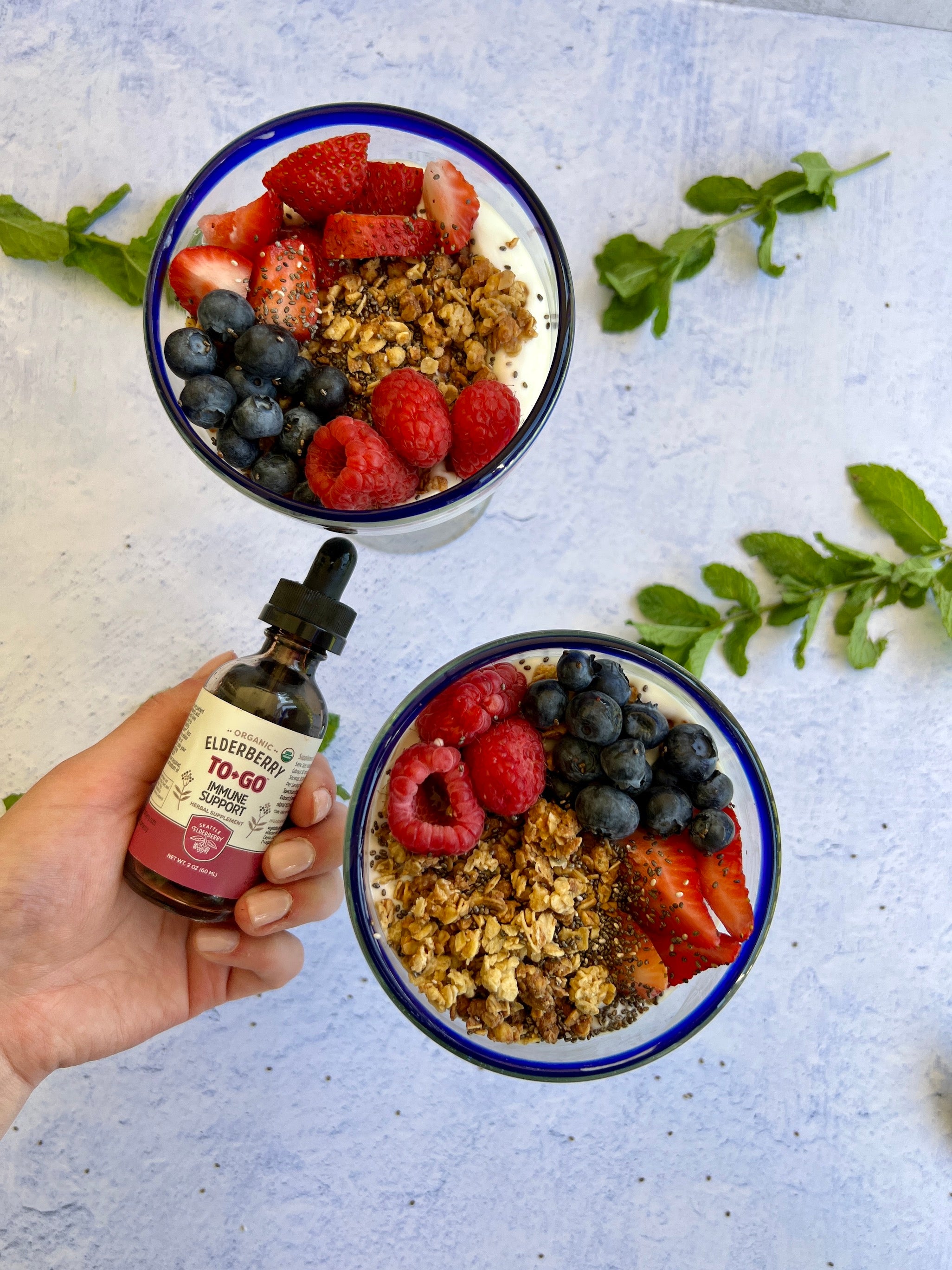yogurt partait with granola and berries and seattle elderberry immune drops