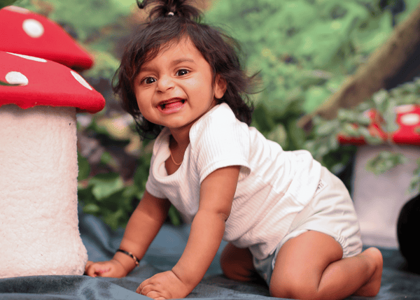 Giggling Baby in a Snazzi Pants All-in-One Cloth Nappy in Sage print from the Brolly Sheets Whimsy Collection