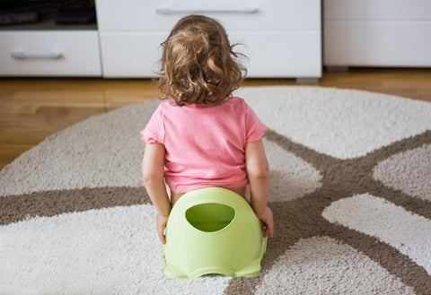 girl sitting on green potty