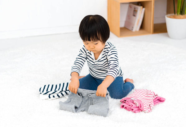 Child folding clothes
