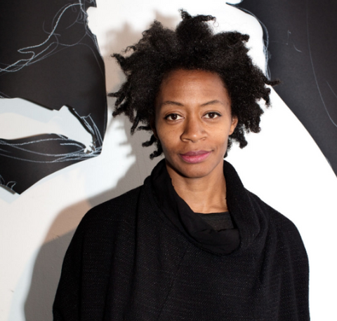 Kara walker in front of one of her black and white pieces