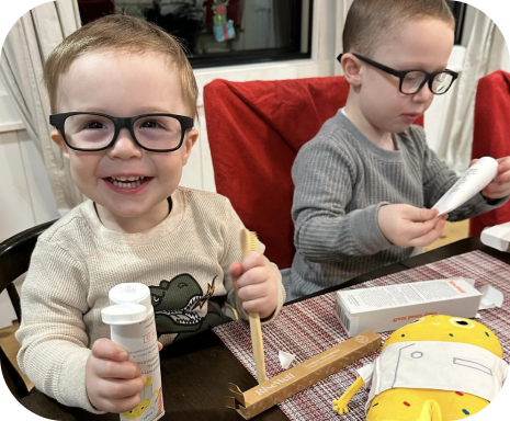 Two Kids with Glasses use RiseWell Pro and Dr. Happy