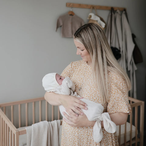 Lifestyle View of Mushie Ribbed Baby Bonnet -ANB Baby