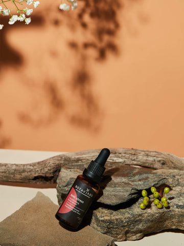 Face serum in a natural environment propped on a log