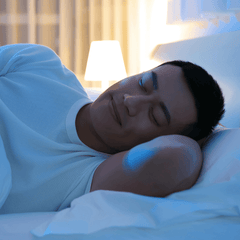 A smiling man sleeping peacefully in bed