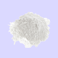 White melatonin powder on a light purple background