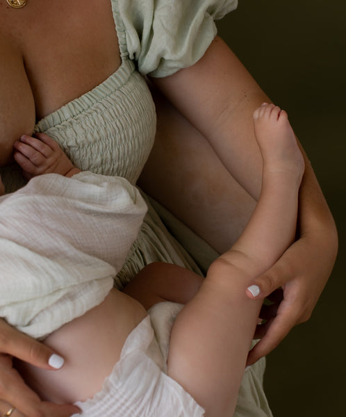 mother holding baby in eco nappy