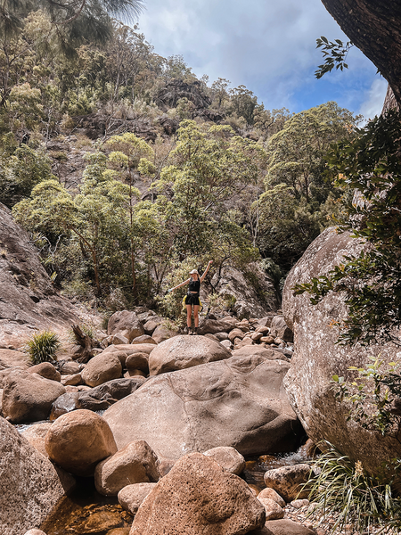 woman posing on a boulder on australian hiking trail