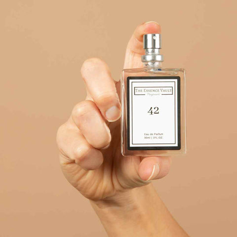Image of a hand holding a perfume from the essence vault, for the blog The Perfect Mist: How To Make Perfume Last Longer