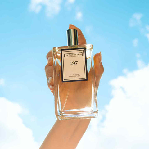 Image of a perfume during the day being held up against bright blue skies, for the blog Discover Your Scent: How to Choose Perfume