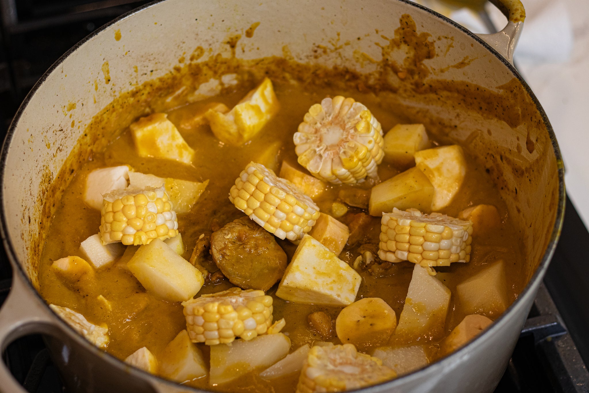 Veggies simmering in a dish while making sancocho