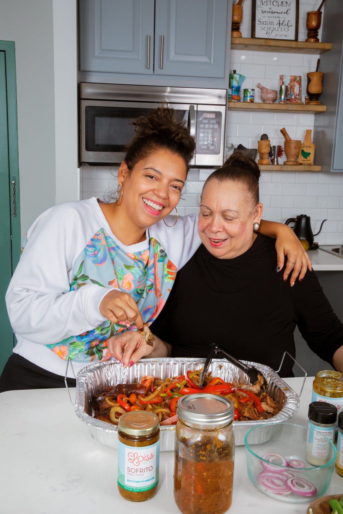 Chef Yadi and her mother Doña Esperanza with their pernil