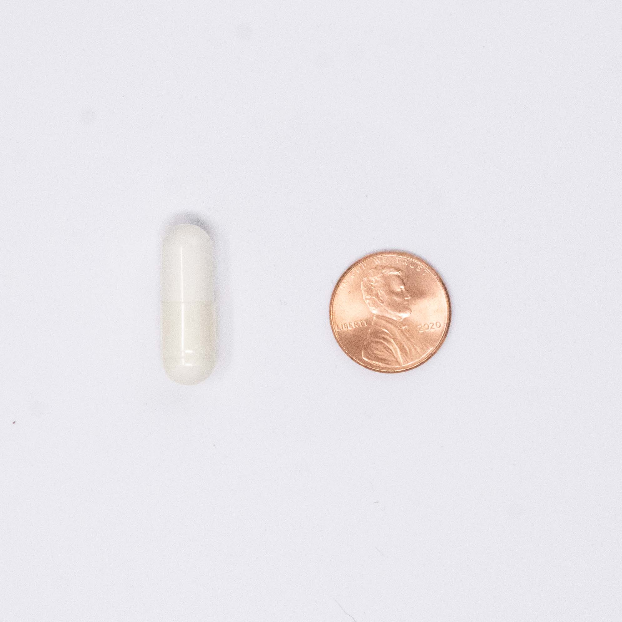 bone support vitamin next to a penny