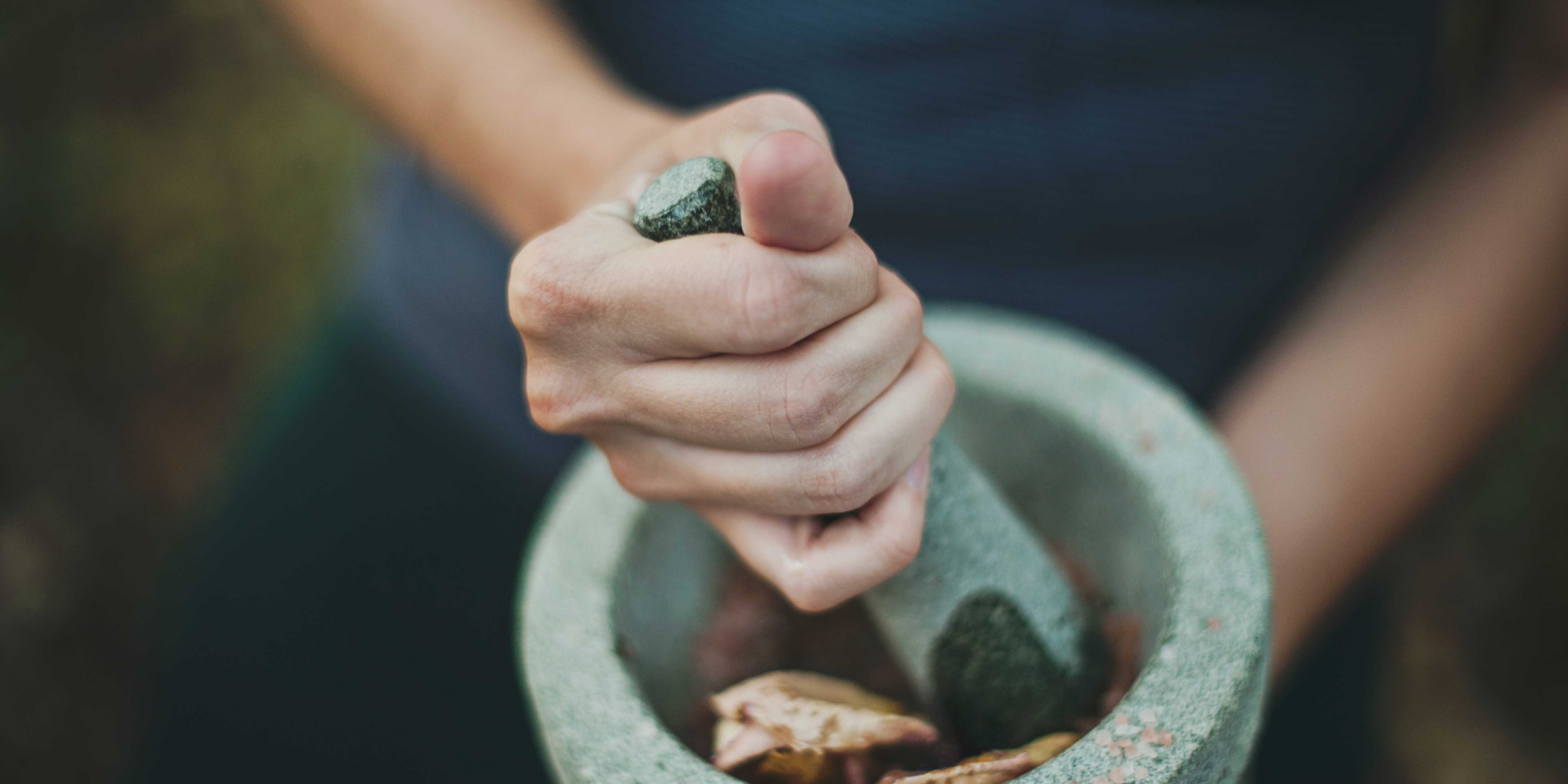 herb grinder crushing leaves